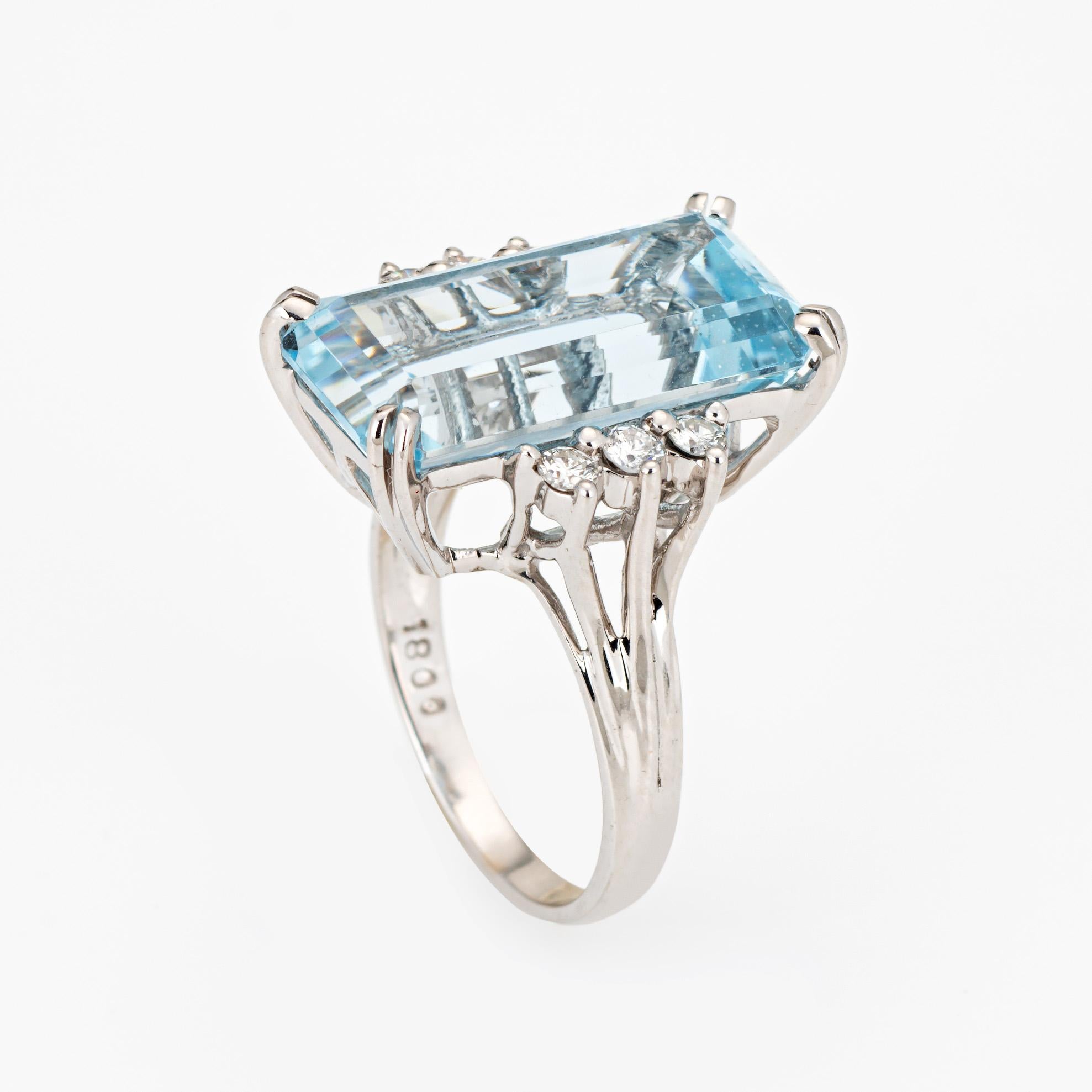 Stylish vintage aquamarine & diamond cocktail ring crafted in 14 karat white gold. 

Emerald cut aquamarine measures 18.5mm x 10mm (estimated at 11 carats). The aquamarine is in very good condition and free of cracks or chips. 6 round brilliant cut