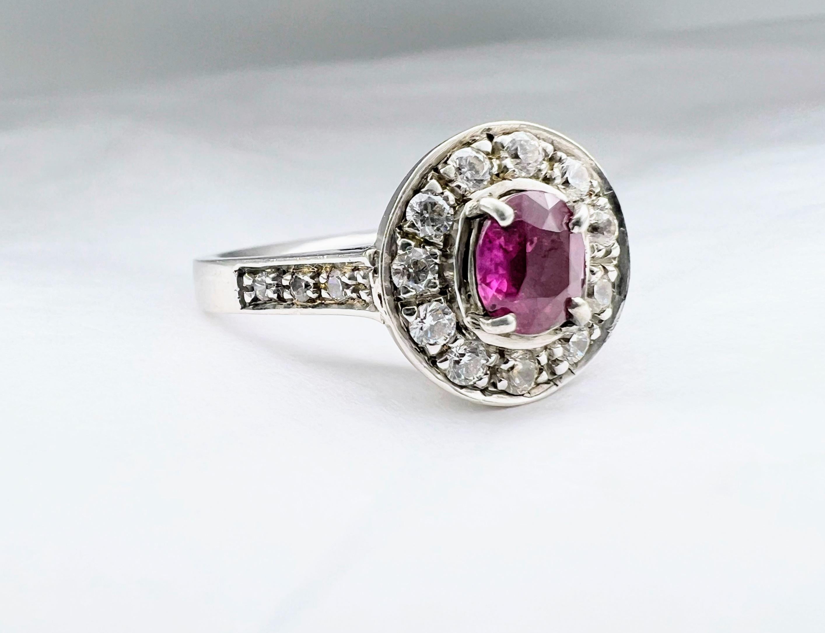 Crafted with clean, contemporary lines, this timeless  1.1ct Oval Cut Pink Sapphire Ring is expertly designed with an oval-cut center pink sapphire set among four slim prongs and surrounded by natural white zircons not to be mistaken for cubic