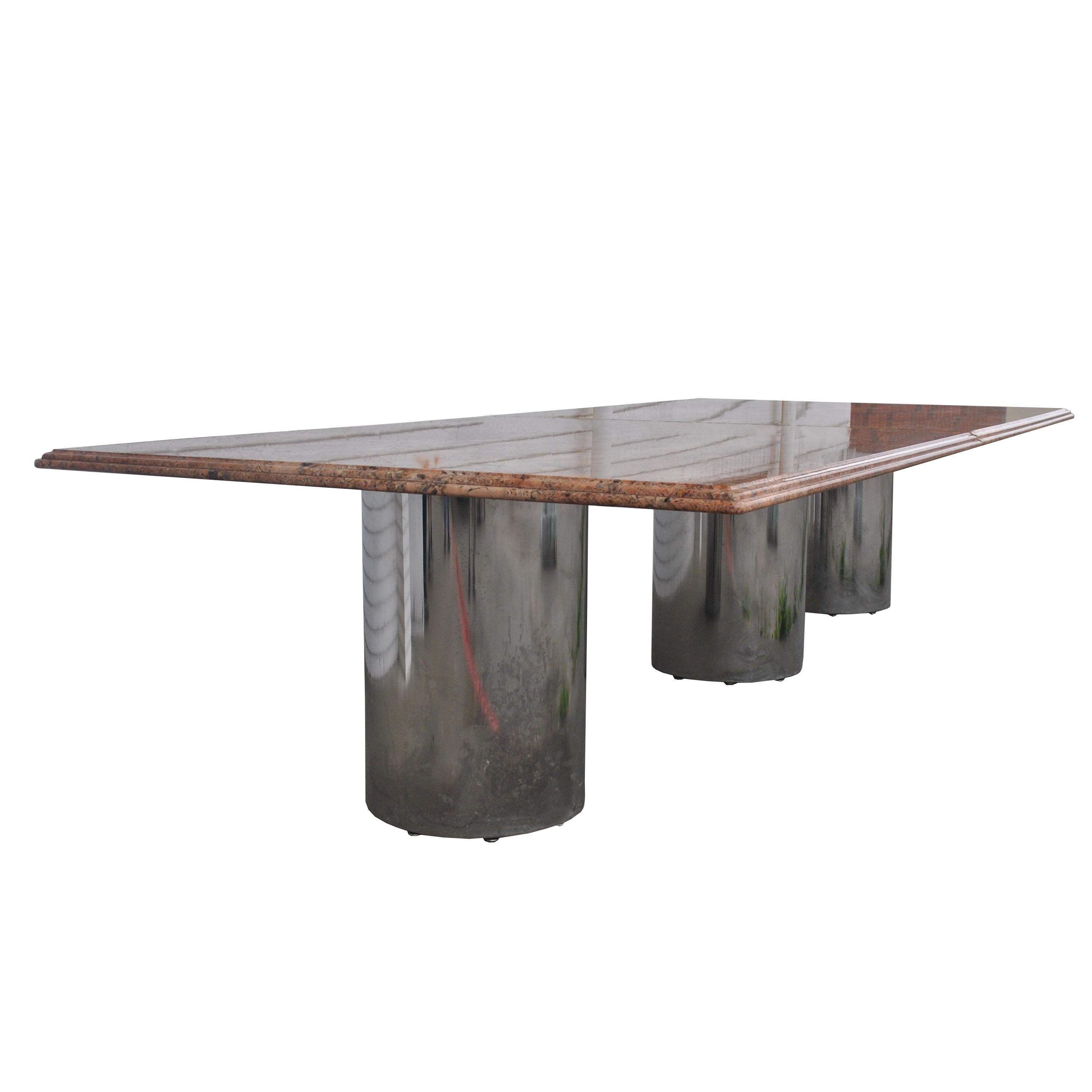 Granite chrome cylinder conference table 

Stunning vintage marble conference table. This table features a rich multicolored roman ogee edge top and three chrome cylinder bases.