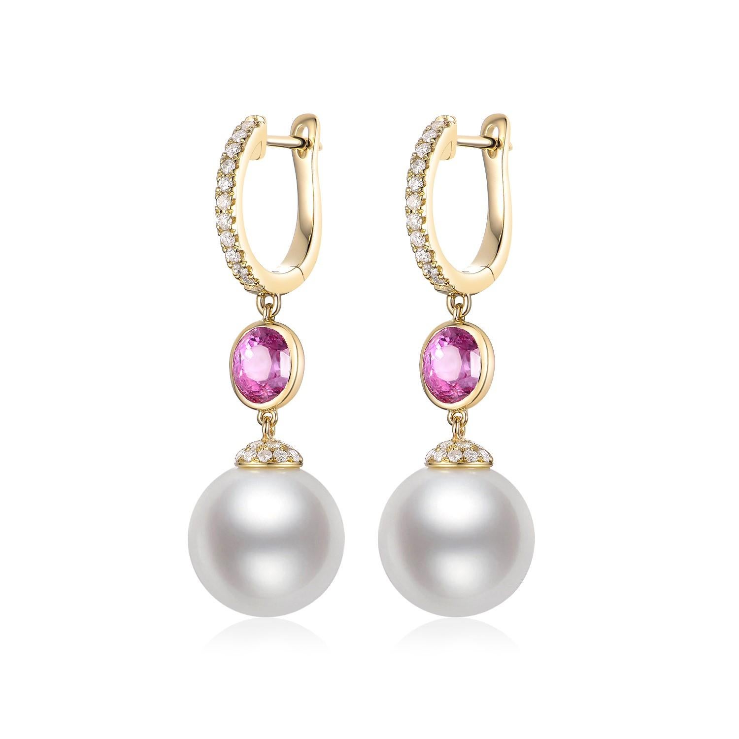 These exquisite dangle earrings feature the classic elegance of South Sea pearls combined with the vibrant allure of pink sapphires and the timeless sparkle of diamonds, all set in warm 14-karat yellow gold. The design begins with a hoop, delicately