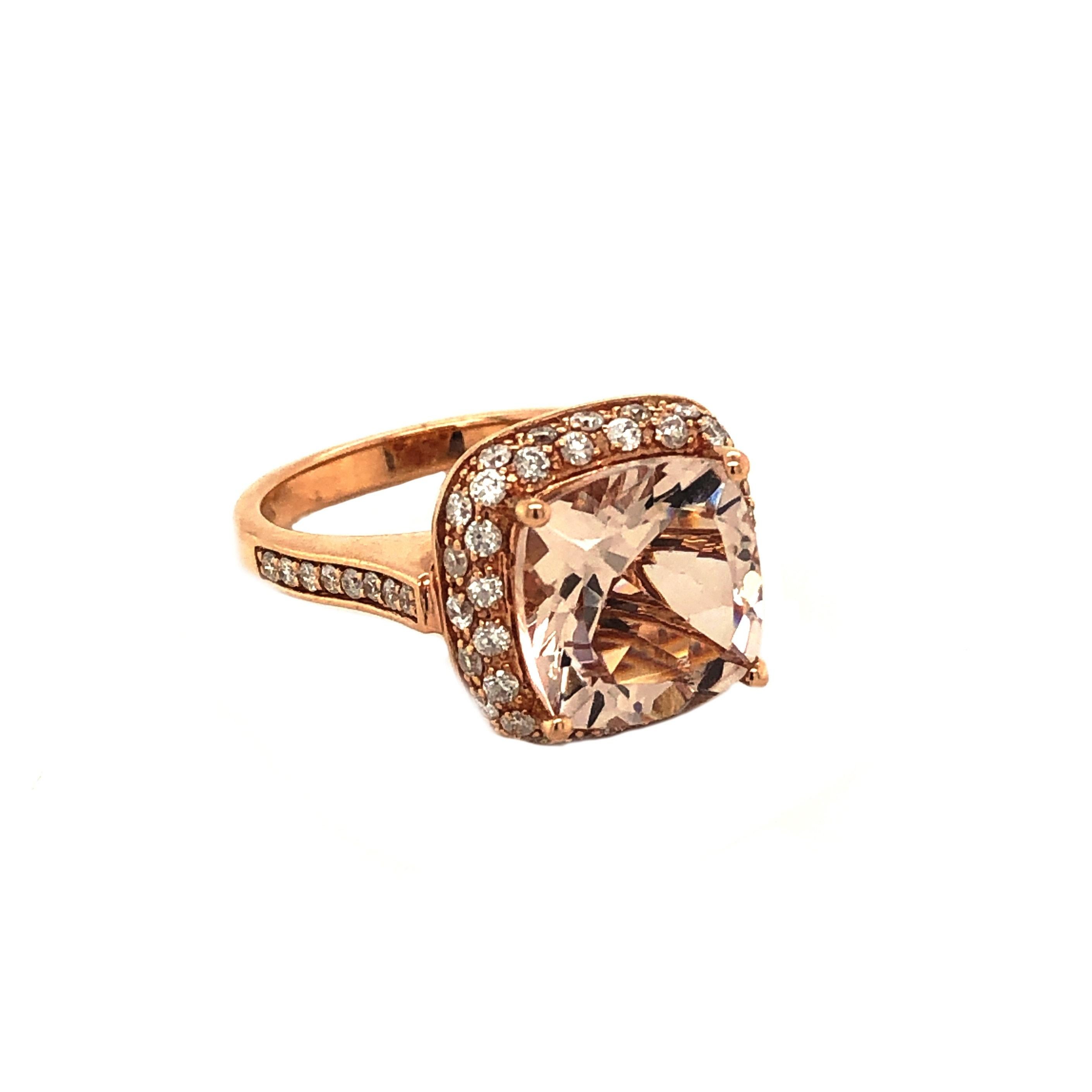 This is a gorgeous natural morganite and diamond ring set in solid 14K rose gold. The natural 11MM cushion cut morganite has an excellent peachy pink color and is surrounded by a halo of round cut white diamonds. The ring is stamped 14K and is a