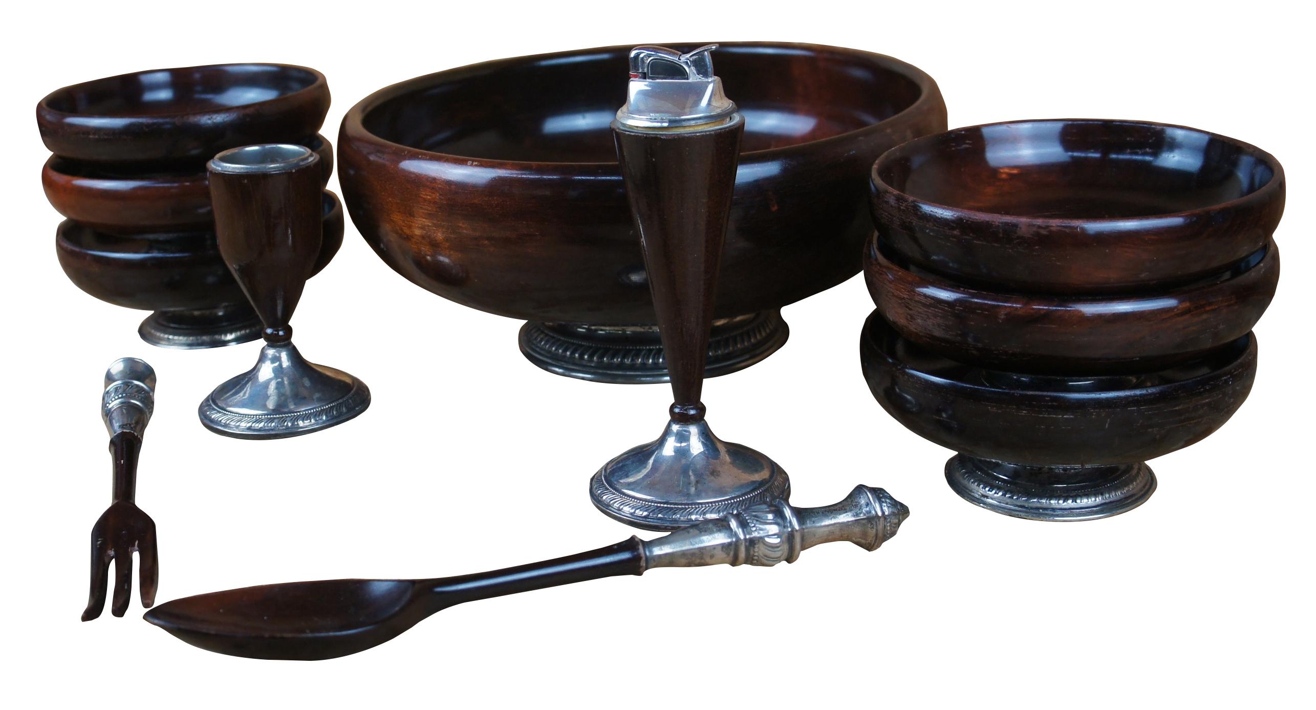 Mid century eleven piece Arrowsmith salad serving set featuring turned mahogany bowls with sterling silver 925 accents, including tongs and unique candlestick form lighter with ashtray. Circa 1960s.

server 1- 11.25