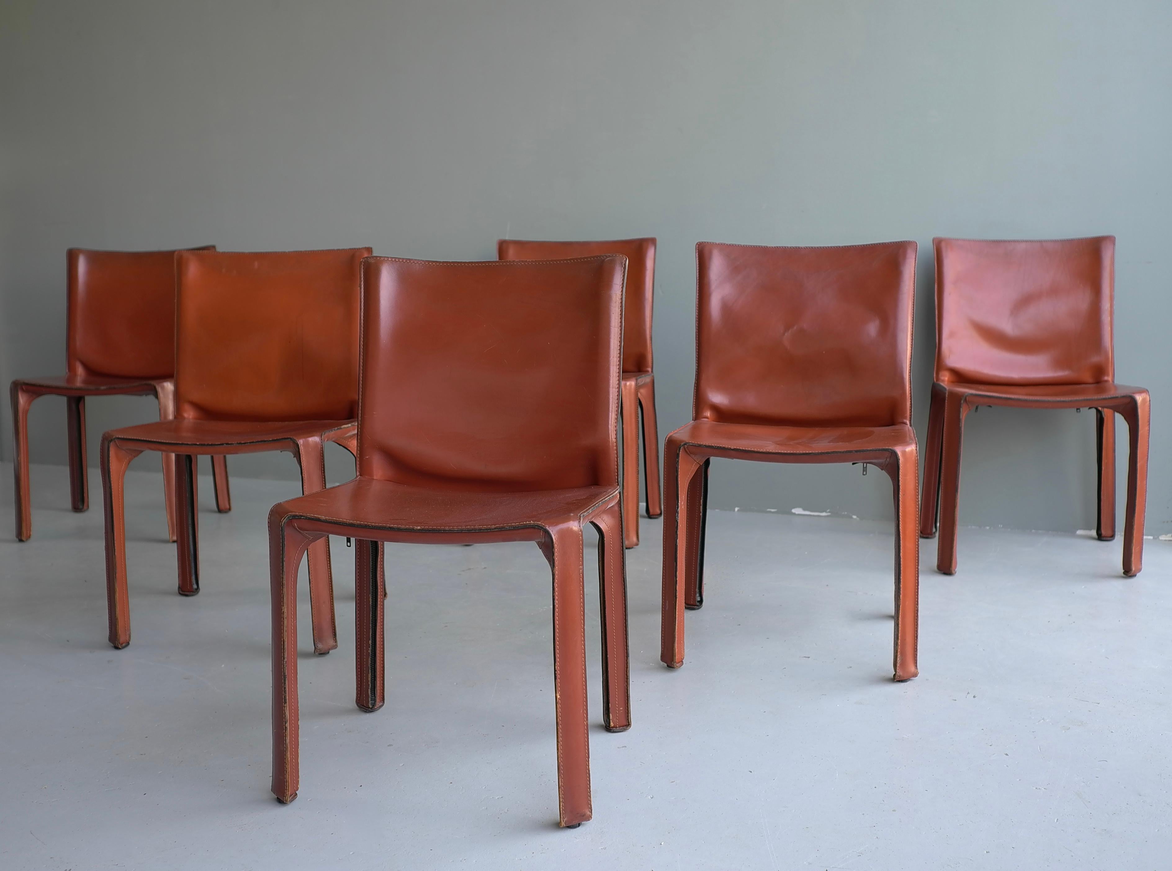 11x leather 412 cab chairs by Mario Bellini for Cassina.

Wonderful original patina and wear. Broken in like your favorite baseball glove. 
They have various patina, stains, rubs, scratches and wear. And we wouldn't have it any other way! You