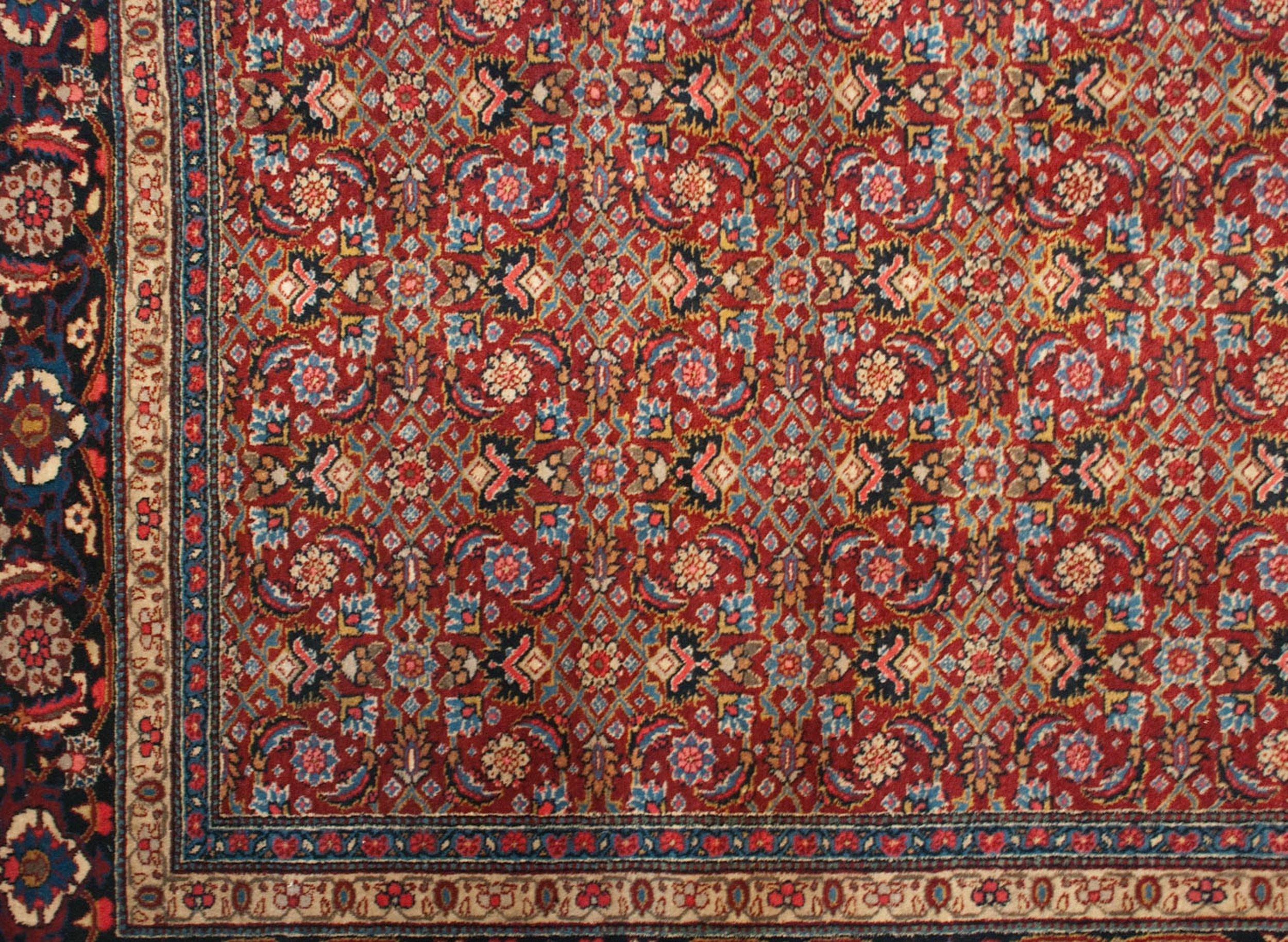 :: Allover repeating Herati motif in a highly intricate rendering with design density defining a faint lattice orientation paneled appearance. Main border in a Samovar, pomegranate, and oversized partial Herati motif, all interconnected by