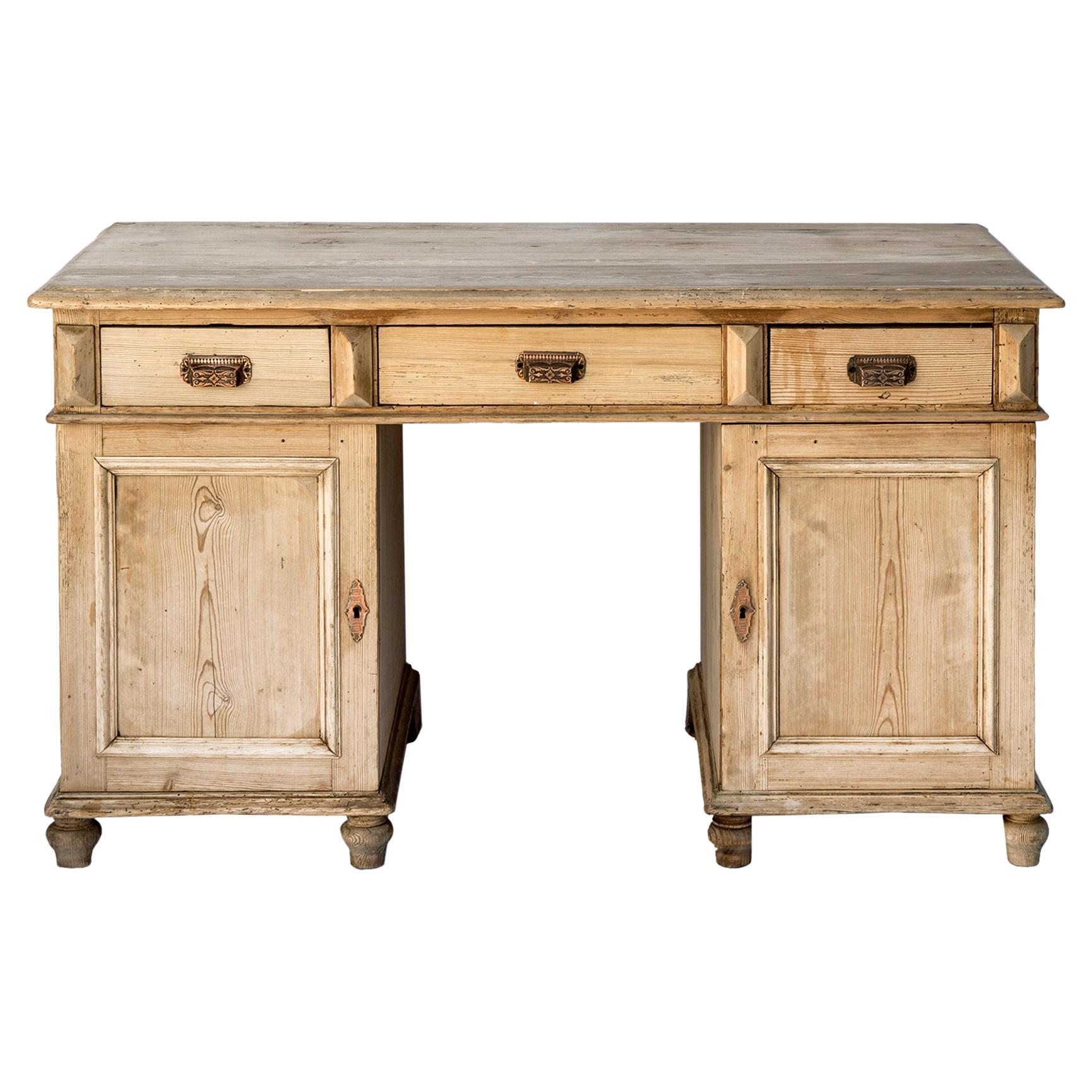 This desk is hand crafted in pine. It features two doors below the drawers on each side of the spacious drawers. 
The desk is constructed in 3 parts; the top segment includes the bank of drawers which sits on the two cabinets with doors.  The