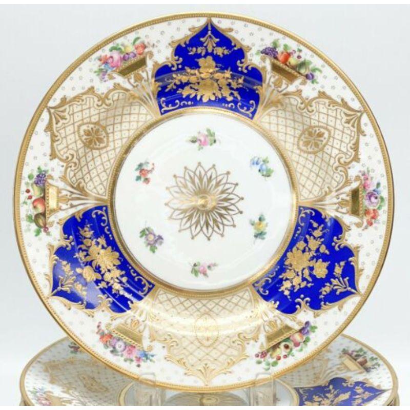 12 Ambrosius Lamm Dresden Germany hand painted porcelain service plates, c 1920

A white ground with blue and cream colored panels framed by raised gilt foliate decoration, hand painted fruits and florals within the gilt baskets. Gilt flower