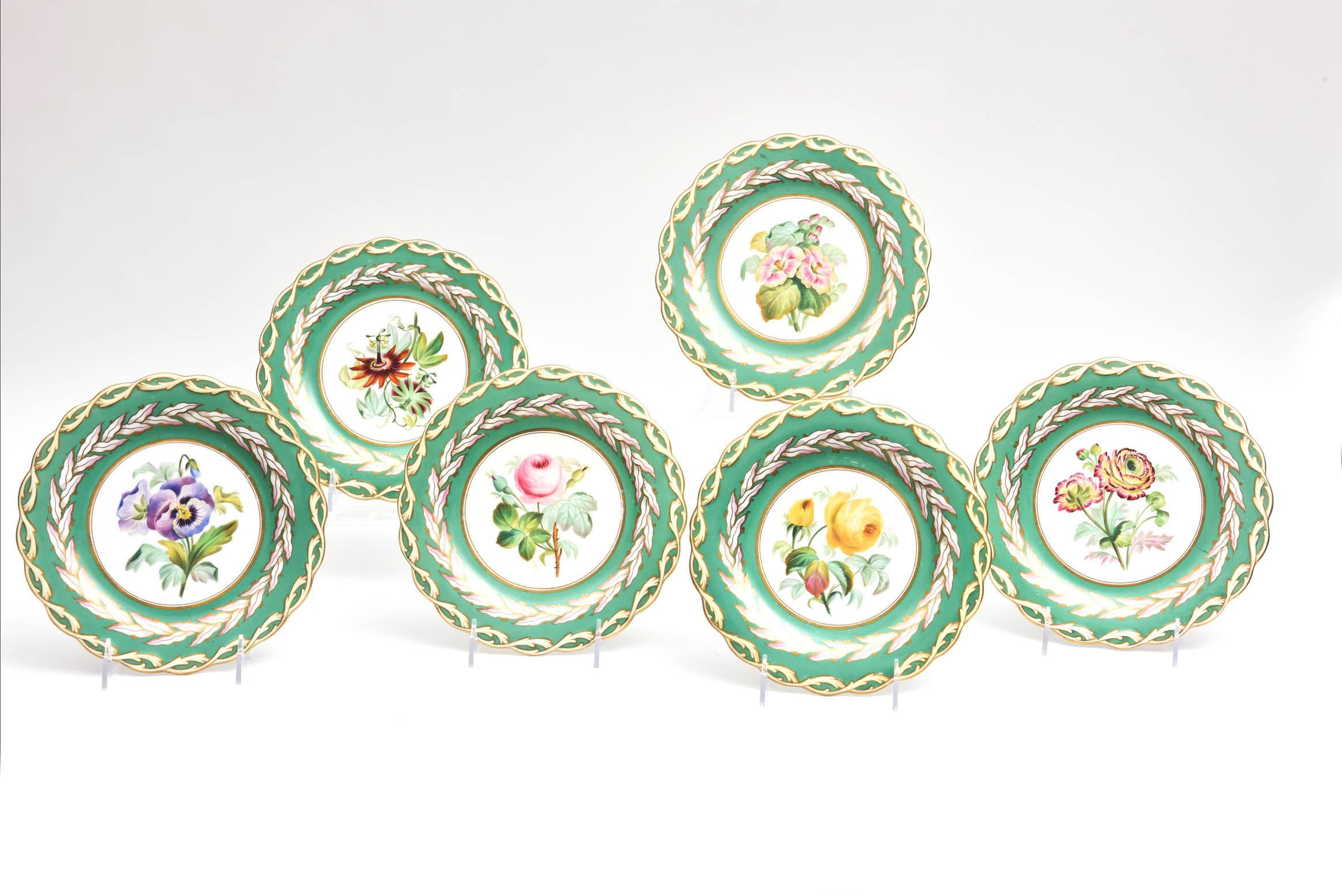 A set of 12 dessert plates or pretty cabinet plates for display. From the mid-19th century, each plate has been hand painted with vibrant detail. An unique scalloped shape and braid border, they have great detail and vibrant collar of green.