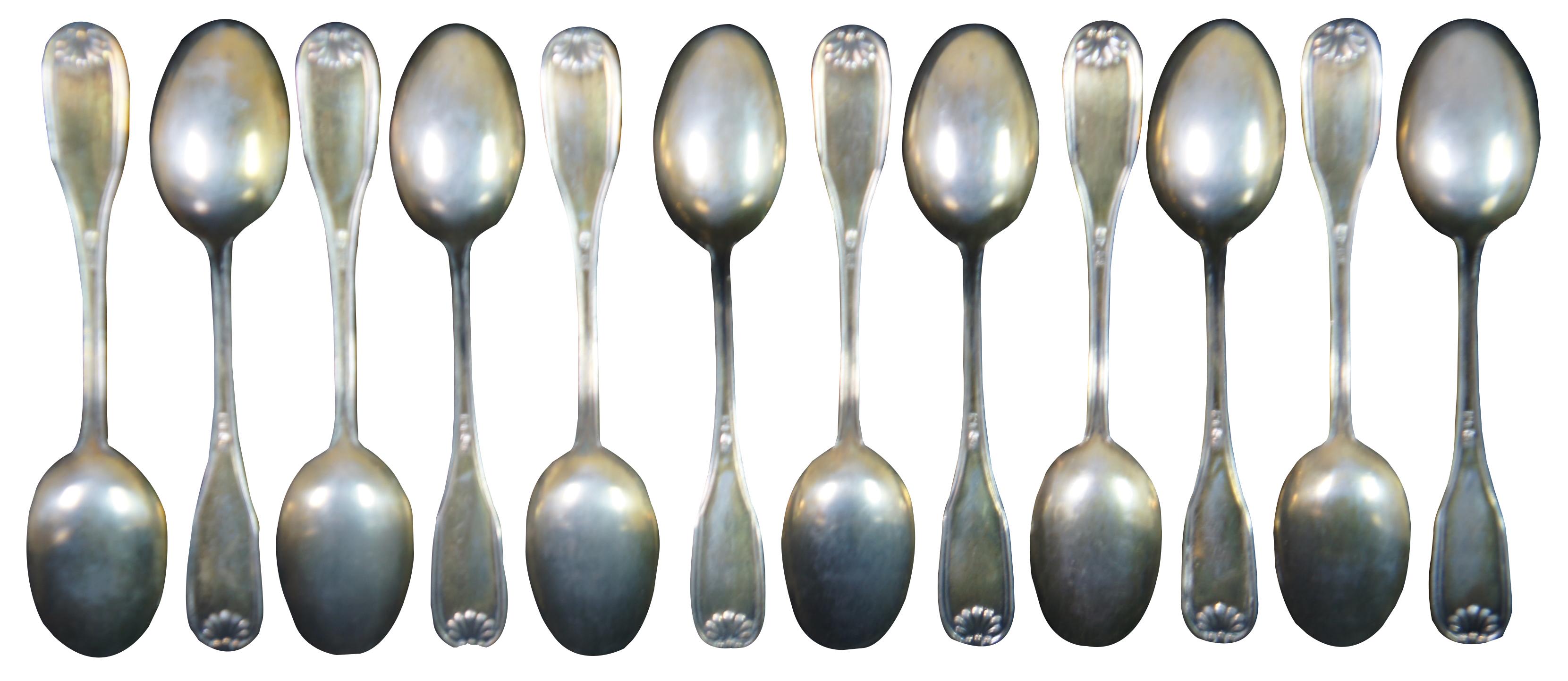 Twelve antique English 800 silver demitasse spoons with scallop shell fiddle, shell and thread pattern.

Measures: 4” x 0.75” / 9g each (length x width).
 
