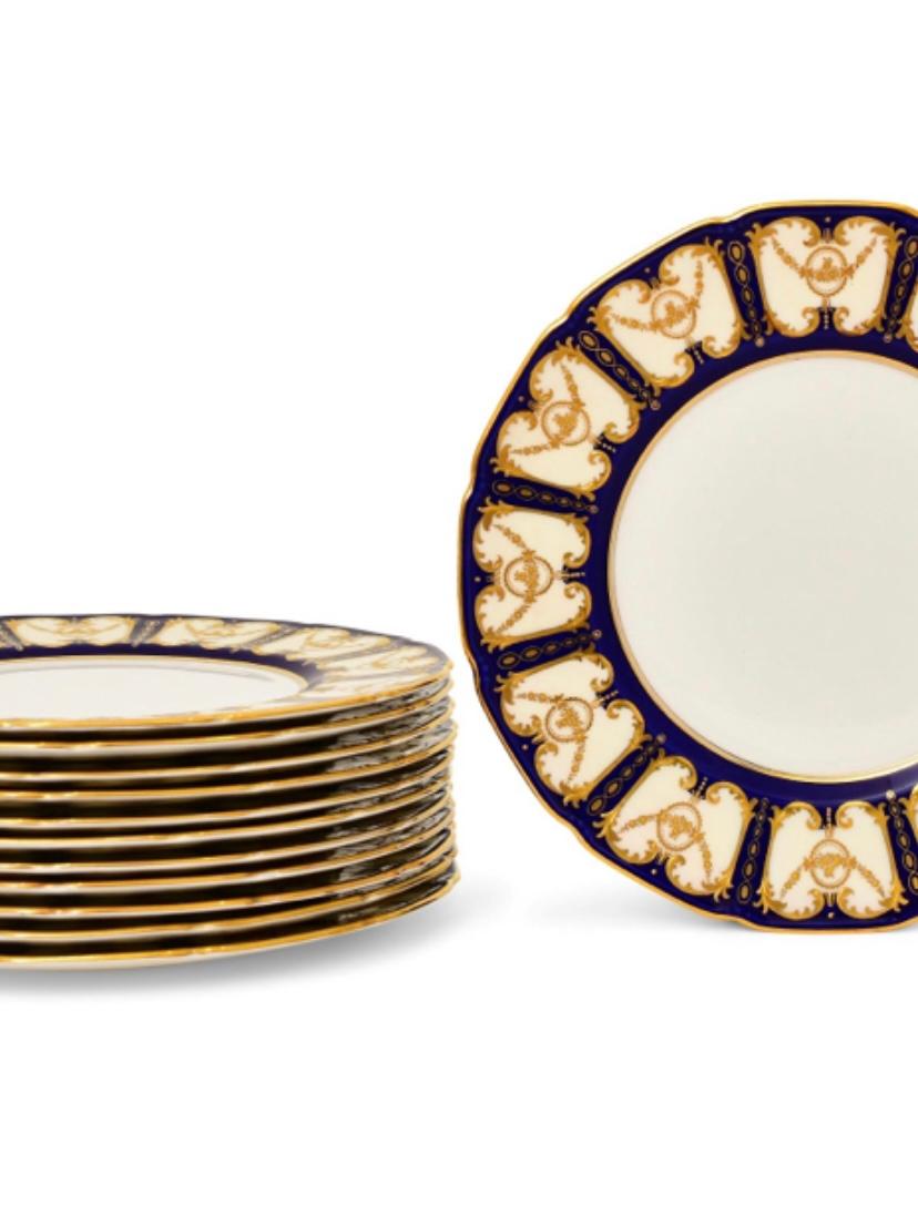 A classic and elegant set of dinner plates by one of our favorite Gilded Age factories of Royal Doulton, England. This set features their Robert Allen designed shape and has cartouches of cobalt blue and raised tooled gilding in their collars. In