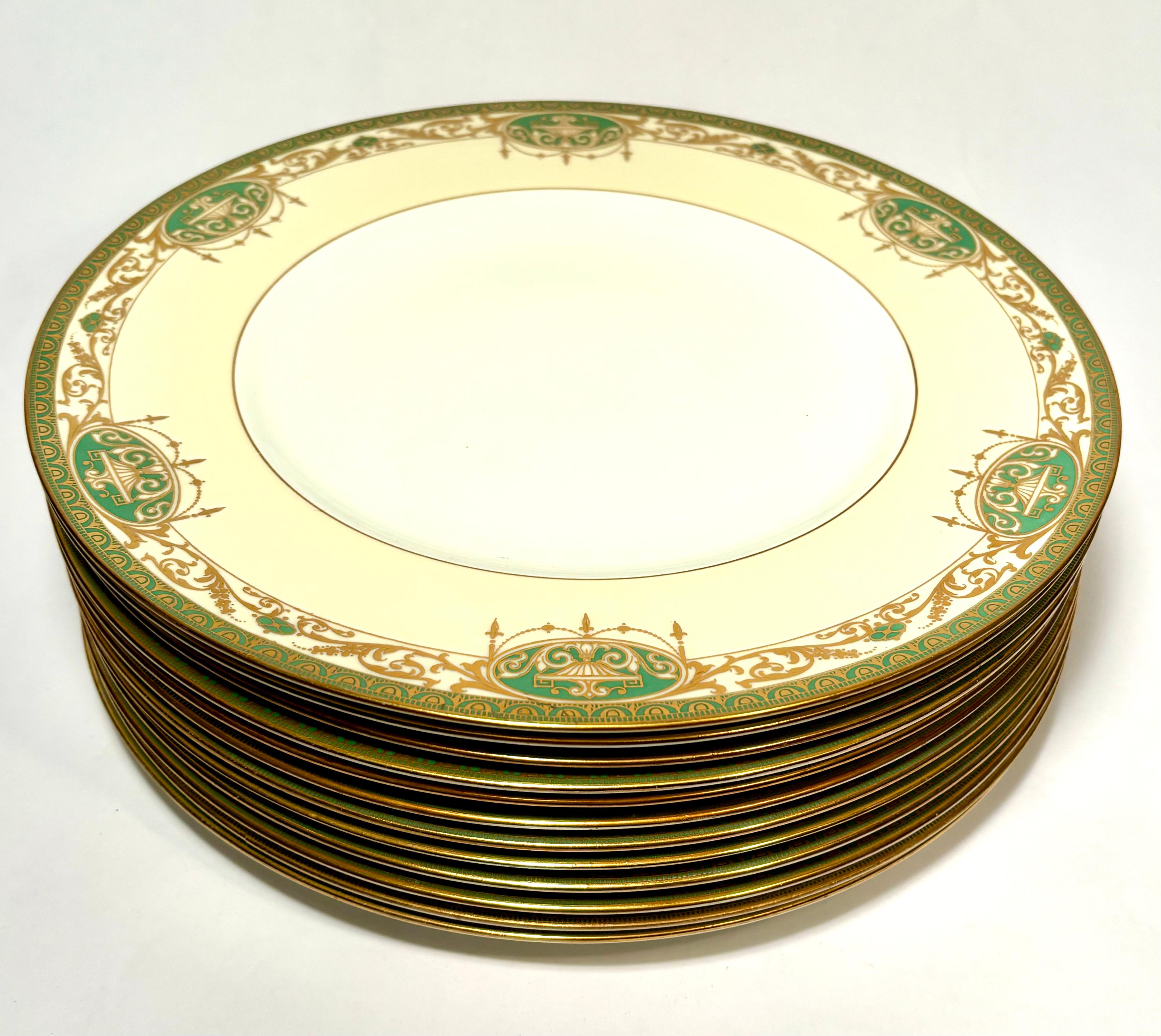 An elegant set of twelve dinner plates from the re known English factory of Royal Worcester. This set features a green and raised gold embossed pattern of classical urn and swag design with just the right amount of cream accent in its collar. In