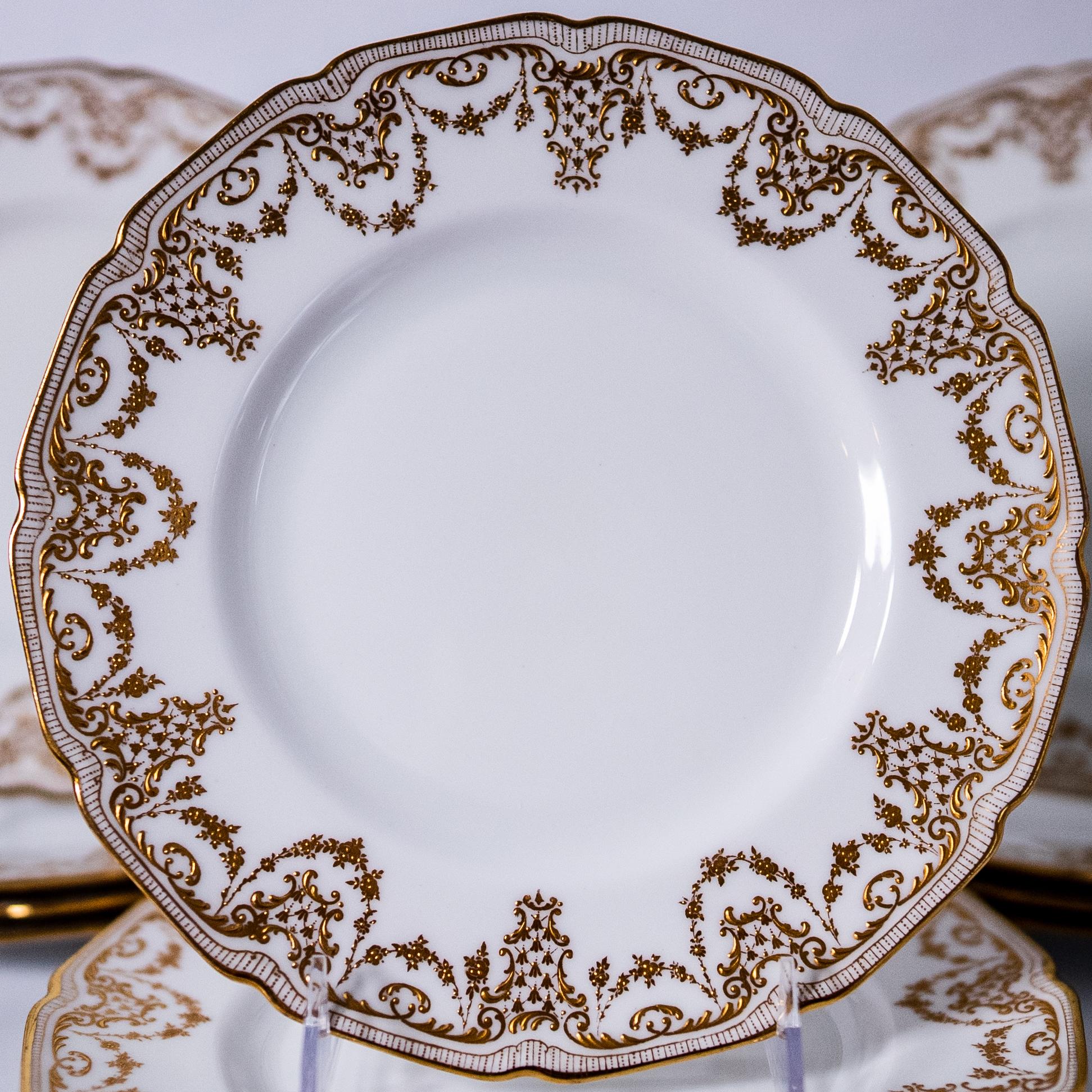 A great set and classic shape from Royal Doulton custom ordered through the fine Gilded Age Retailer: Burley & Co Chicago. These plates feature a crisp white background and are also trimmed in 24 karat gold. In really nice antique condition.