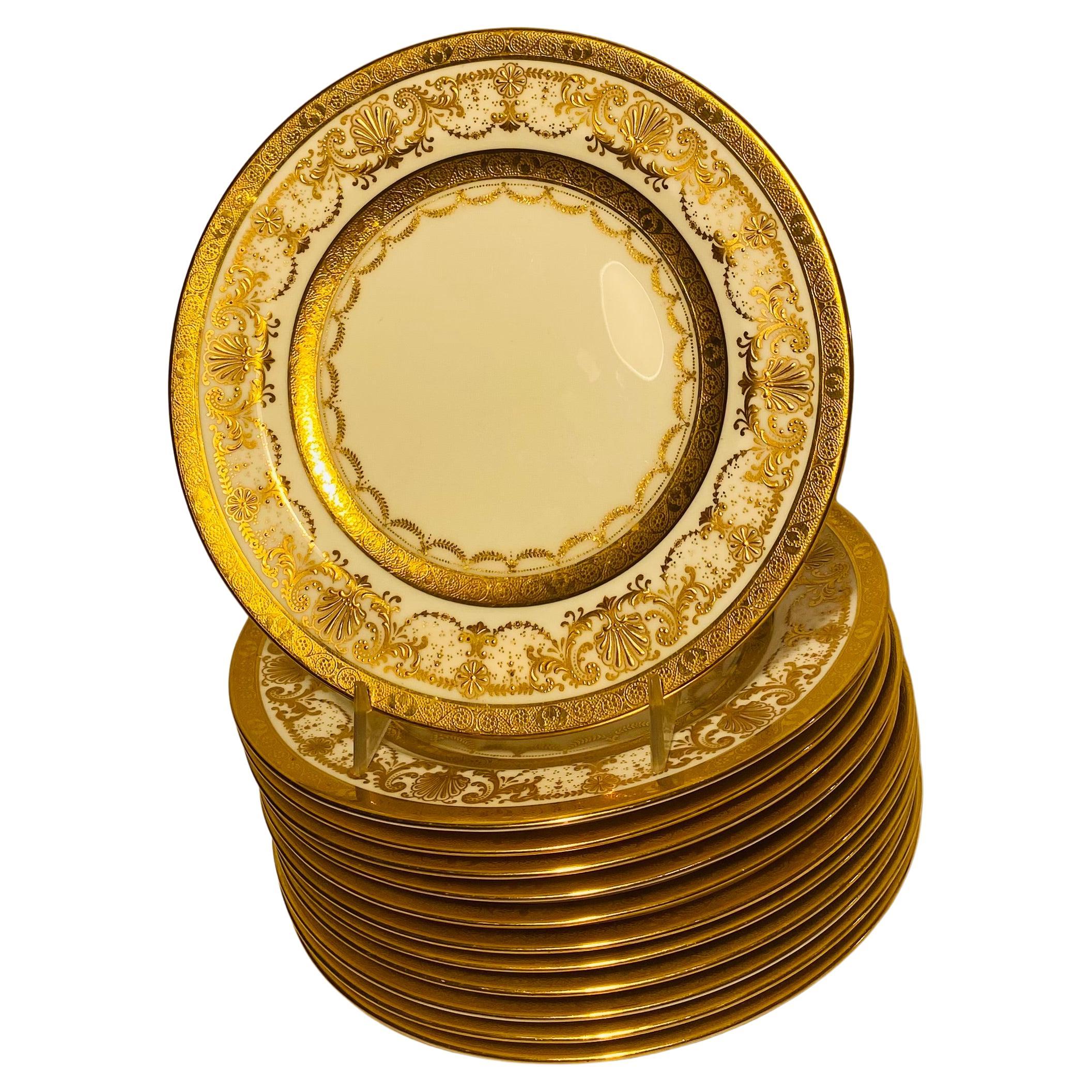 A classic and elegant set of 12 plates made by the storied Gilded Age firm of Cauldon England. This versatile size features raised and hand tooled gilding on their elaborate collars with a nice clear center for use. Perfect for mixing and matching