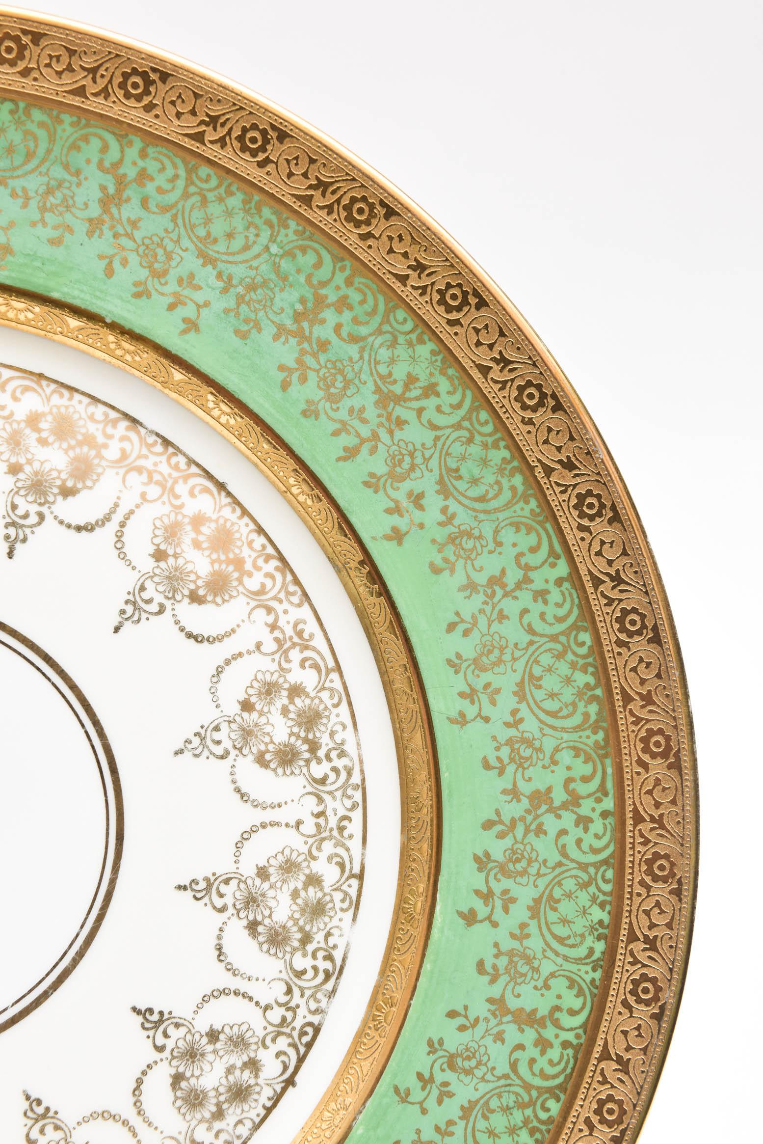 A vibrant colored set of 12 generously proportioned dinner, presentation or charger plates ready to mix and match in with all your Fine tabletop. This set features a dark green collar with all-over gilt foliate decoration that flows to the center of