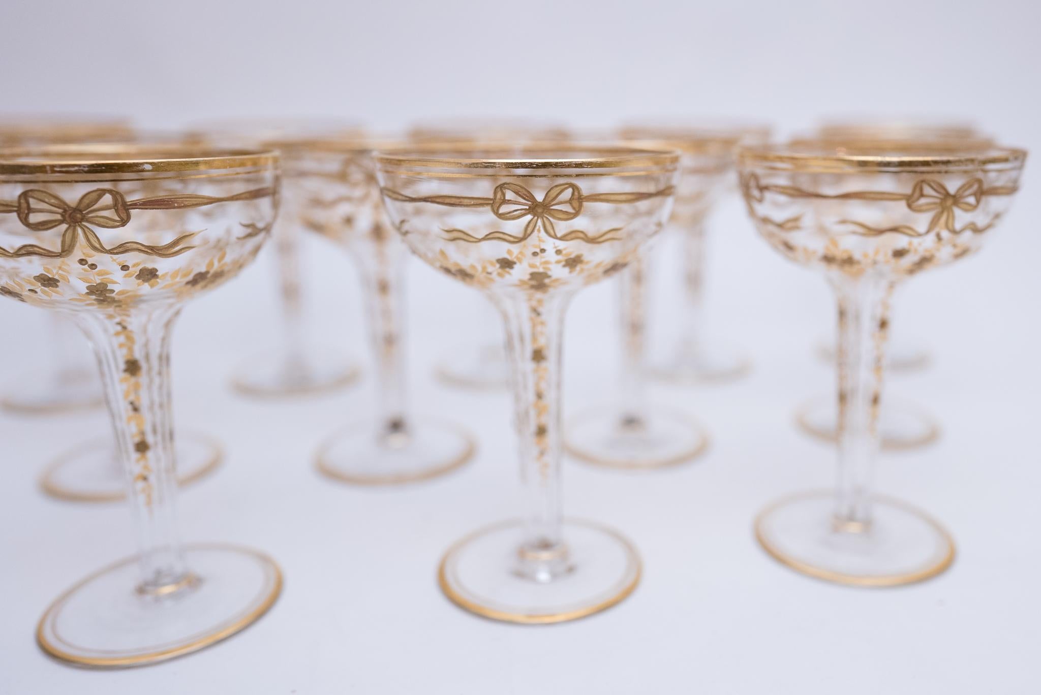We were delighted to find a set of 12 antique hollow stem champagne glasses with all this pretty raised gilding throughout, all the way down their stems. They feature a swag and bow along with the floral garlands that trellis down to their bases. We