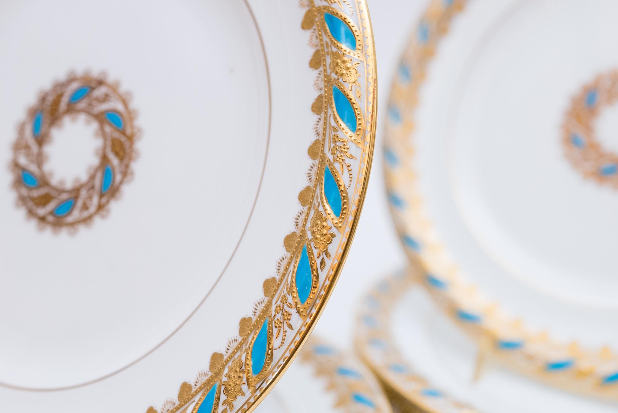 Another beautiful custom ordered set of dinner plates by the re known English factory of Brown Westhead and Moore which later became Cauldon. This design features a highly sculpted collar with ribbons of turquoise enamel and raised gilt encrusted