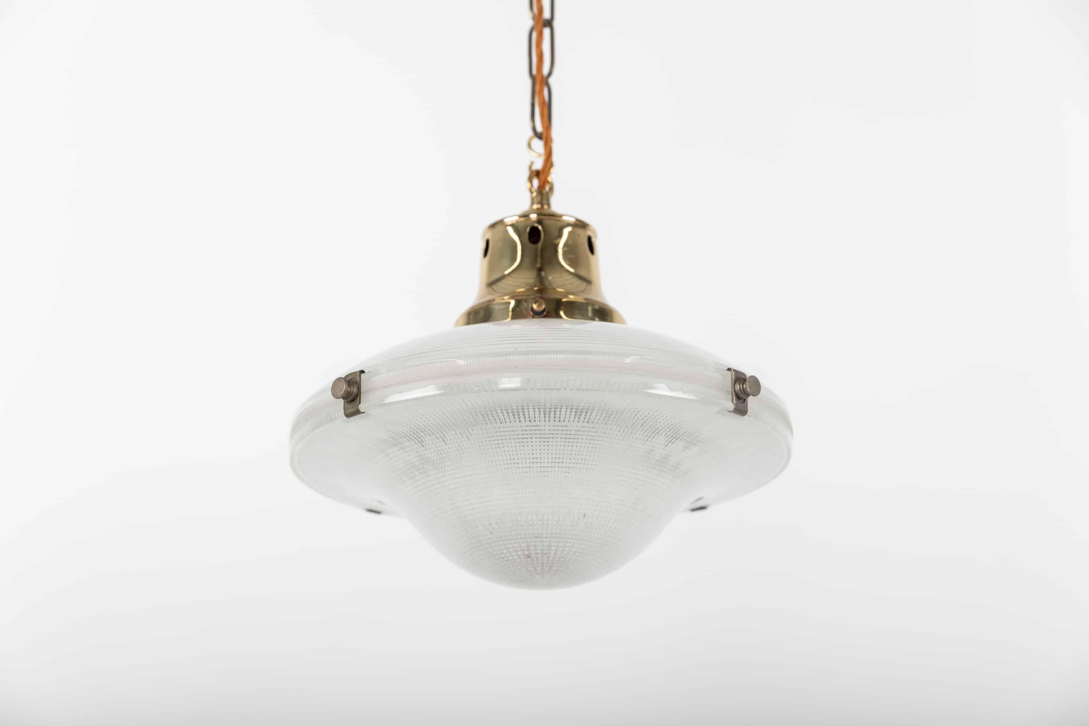 A beautifully designed glass reflector pendant light made in England by Holophane. c.1920

Often wrongly coined as 'flying saucers', the correct name being the 'Ripple-lite’ - this two-part glass reflector shade has survived in wonderful condition