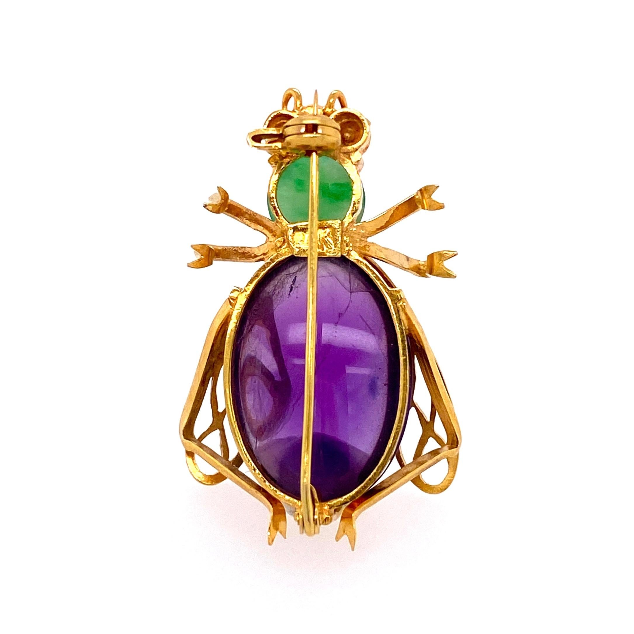Simply Beautiful, Stylish and finely detailed 12 Carat Amethyst, 0.80 Carat Jade Cool Bug Brooch Pin with Ruby Eyes. Hand crafted in 14 Karat yellow Gold. Circa 1960s. The Pin is in excellent vintage condition and recently professionally cleaned and