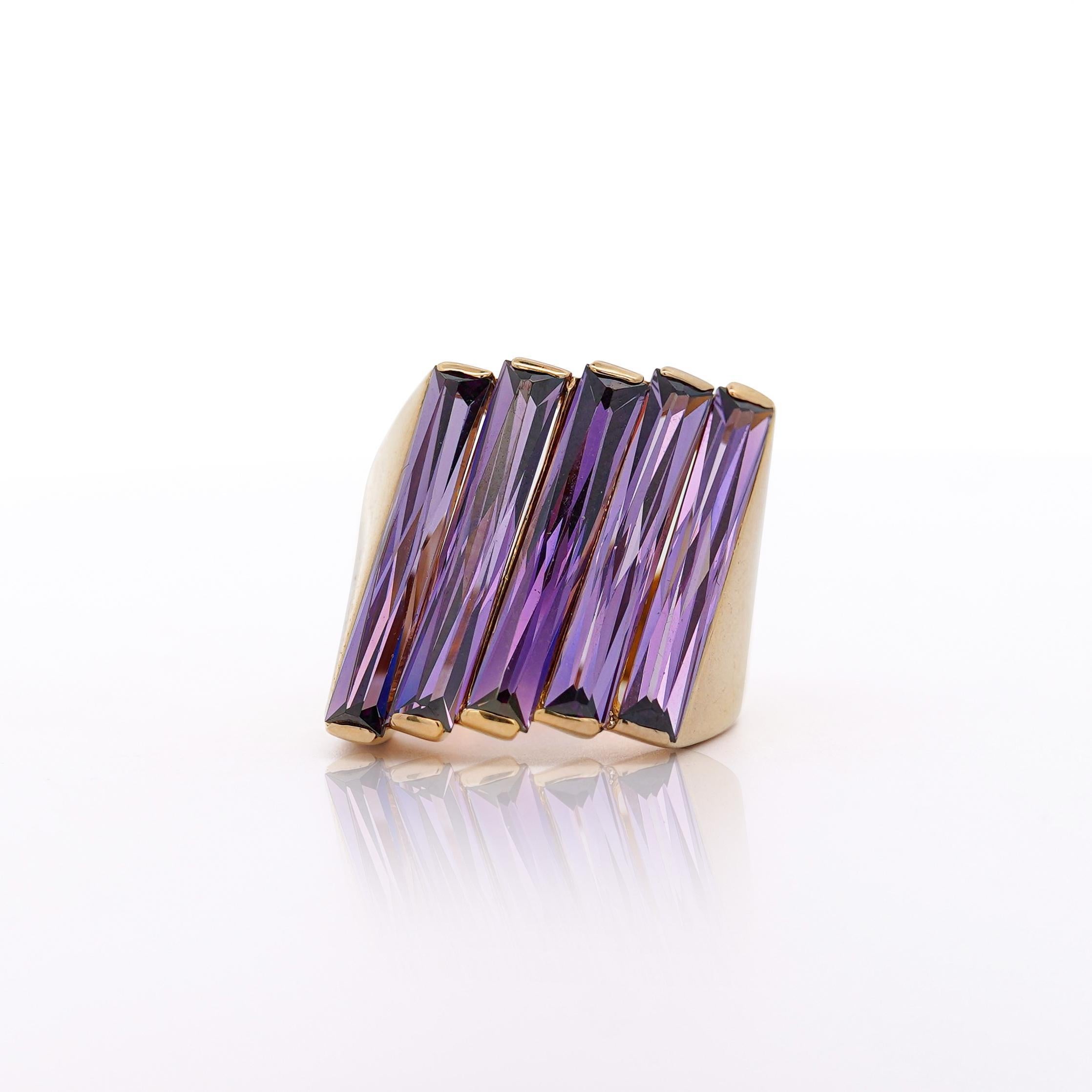 Vintage Amethyst Cocktail Ring 18KY (Italian made) - Amethyst - 12ct (long baguette cut) / 14.5g / 7.5 ring size

This vintage 18K yellow gold cocktail ring features 12 carats of long baguette-cut purple amethysts, showcasing bold Italian