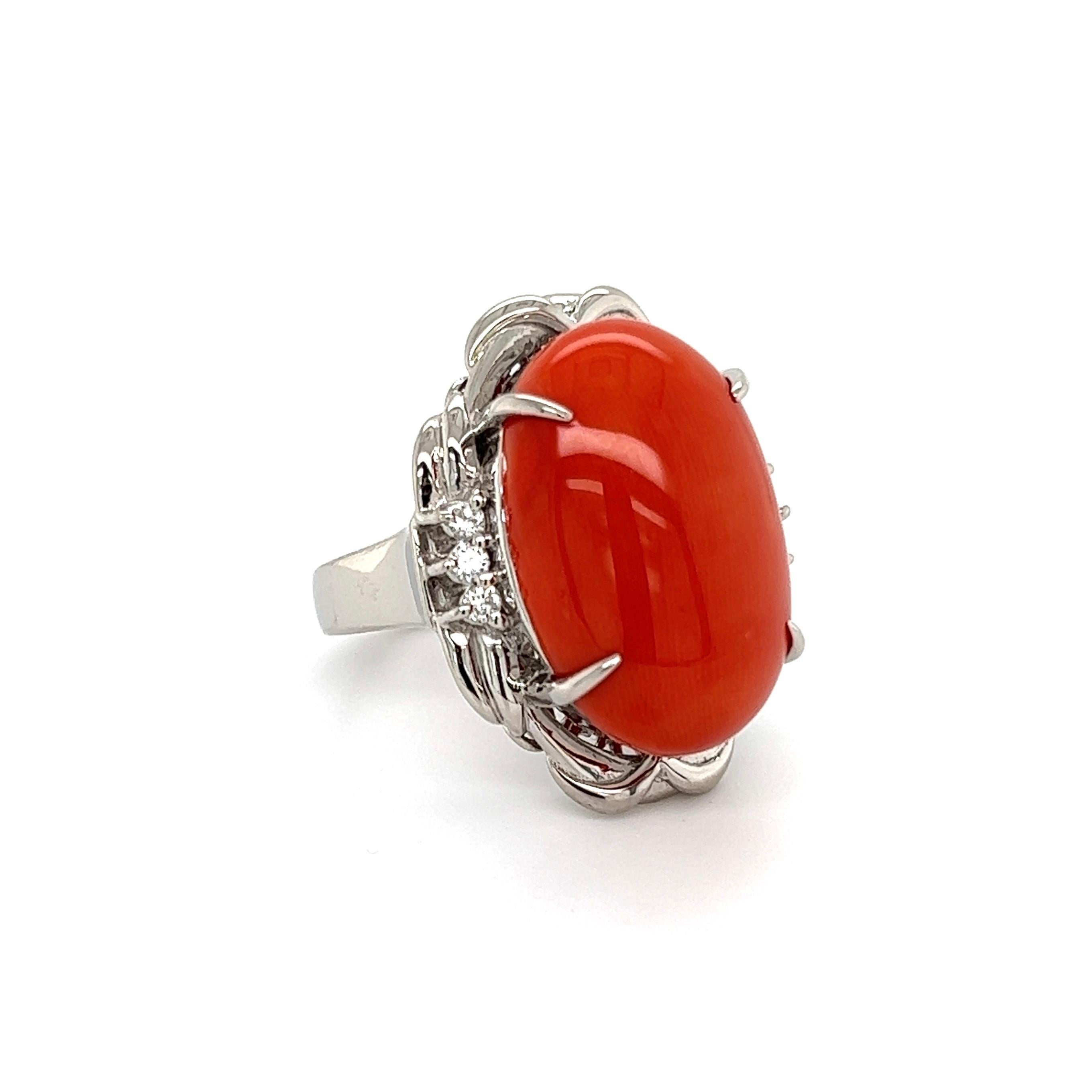 Simply Beautiful! Finely detailed Cabochon Red Coral and Diamond Cocktail Ring. Center securely set with an Awesome 12 Carat Cabochon Red Coral, accented by Diamonds, weighing approx. 0.16tcw. Hand crafted Platinum mounting. Approx. dimensions: