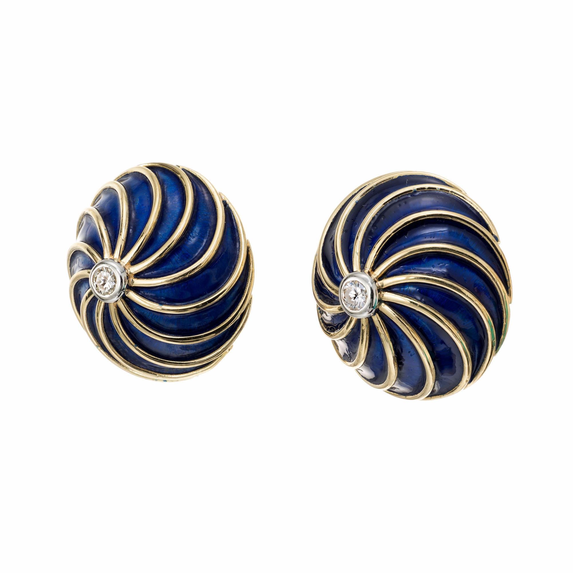 Round diamond and blue enamel swirl design earrings in 18k yellow gold.

2 round brilliant cut diamonds, H VS approx. .12cts.
18k yellow gold 
Stamped: 18k
9.1 grams
Top to bottom: 18.4mm or .75 Inch
Width: 18.4mm or .75 Inch
Depth or thickness: