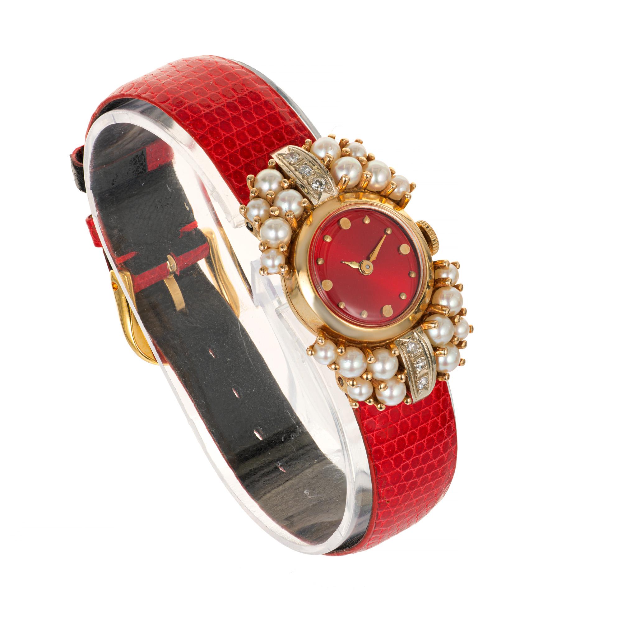 1950's Lady in red wristwatch. Bright, customized red dial by Peter Suchy Jewelers. Manual wind movement. Bright red band.

20 cultured crème color pearls 2.1mm -2.8mm
6 single cut diamonds VS-SI G-H color approx. .12cts 
Length: 34.37mm
Width: