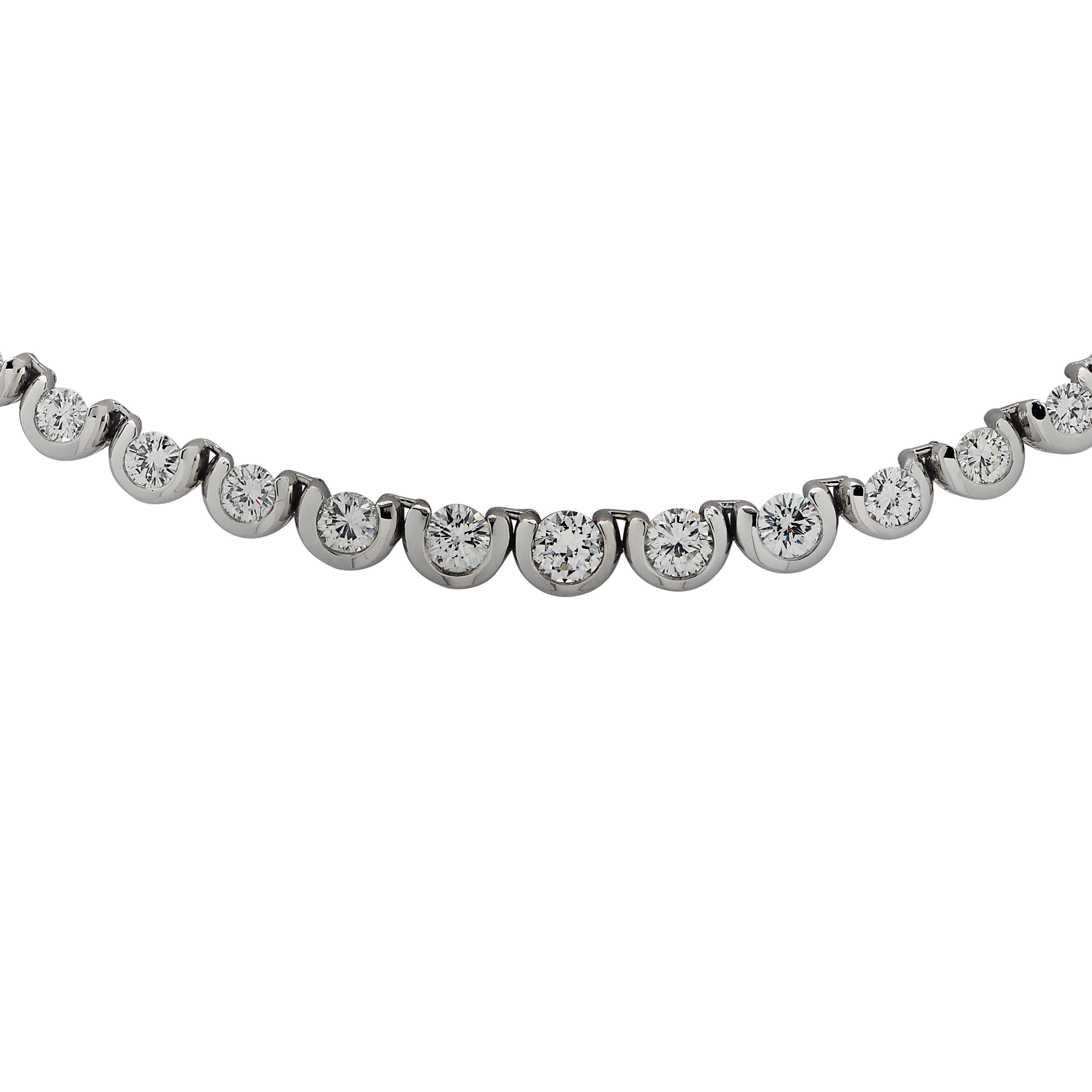 Exquisite diamond necklace crafted in 18 Karat white gold, showcasing 68 round brilliant cut diamonds weighing approximately 12 carats total, G color, SI Clarity. The diamonds are set in a half bezel creating a spectacular symphony of brilliance and