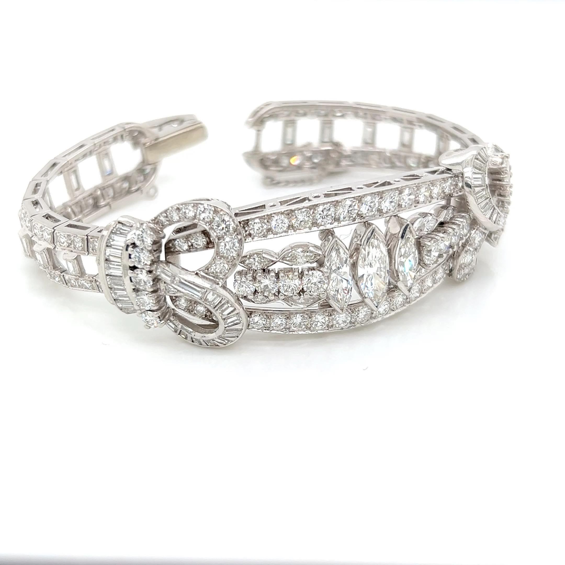 This exquisite bracelet, crafted from 18 karat white gold, features a stunning 12 carats plus (estimated) of meticulously cut diamonds. Its design showcases a harmonious blend of marquise-cut and round brilliant-cut diamonds with some baguettes and