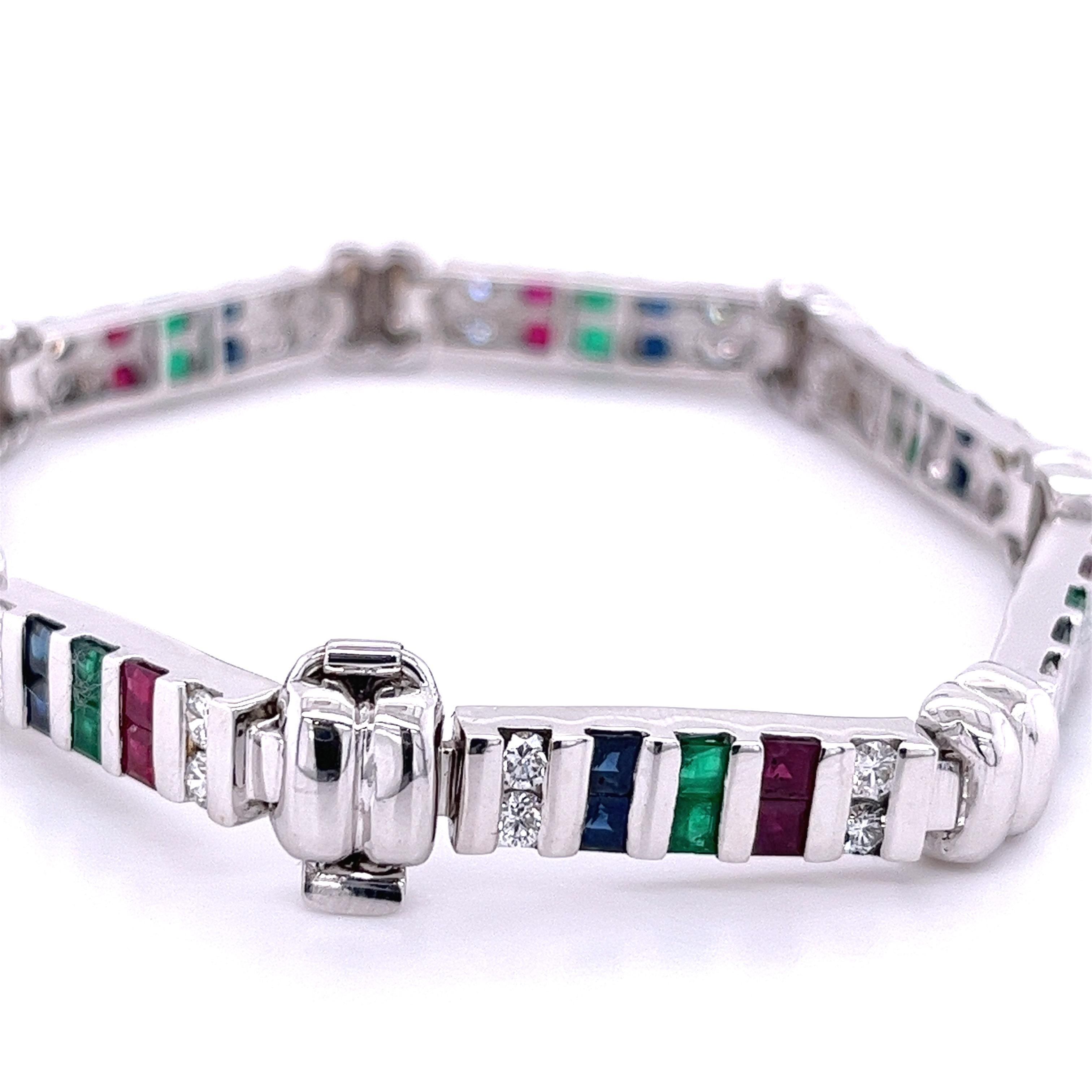 Set in 18K White Gold and accented by roughly 12 total carats of matching Diamonds, Emeralds, Rubies and Sapphires, this vintage bracelet is a finely-crafted, marvelously-designed jewel.

Details:
✔ Stone(s): Diamond, Emerald, Ruby, Sapphire 
✔