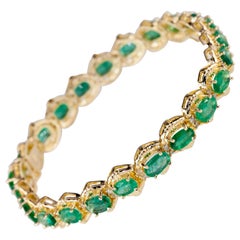 12 Carat Emerald and Diamond Tennis Bracelet in Yellow Gold