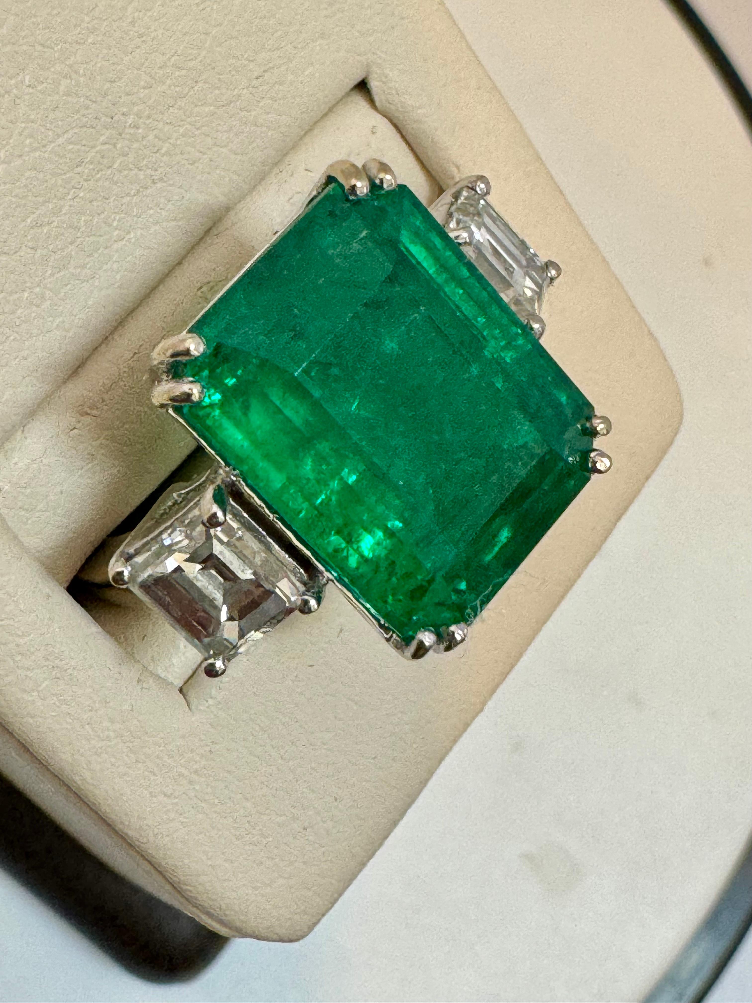 Approximately 12 Carat Emerald Cut Colombian Emerald & 1.6 Ct Diamond 18 Karat White gold Ring
Estate piece Natural Emerald 
Two Emerald cut Diamonds on either side of the Emerald. 
18 K White gold 10.9 Gm
2 SOLITAIRE  Diamonds: approximate 1.6 ct,