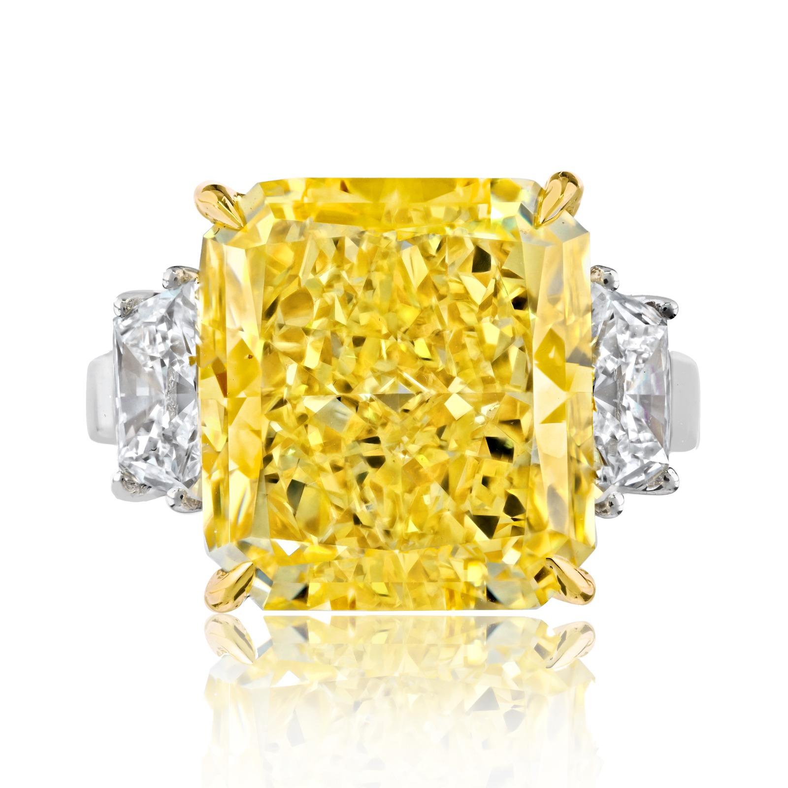 This diamond ring is truly an exceptional piece of jewelry, featuring a very special Fancy Yellow Vivid Radiant Cut Diamond. This diamond is of a remarkable 12 carats and boasts a deep fancy yellow color. 

The ring is mounted in platinum, a metal