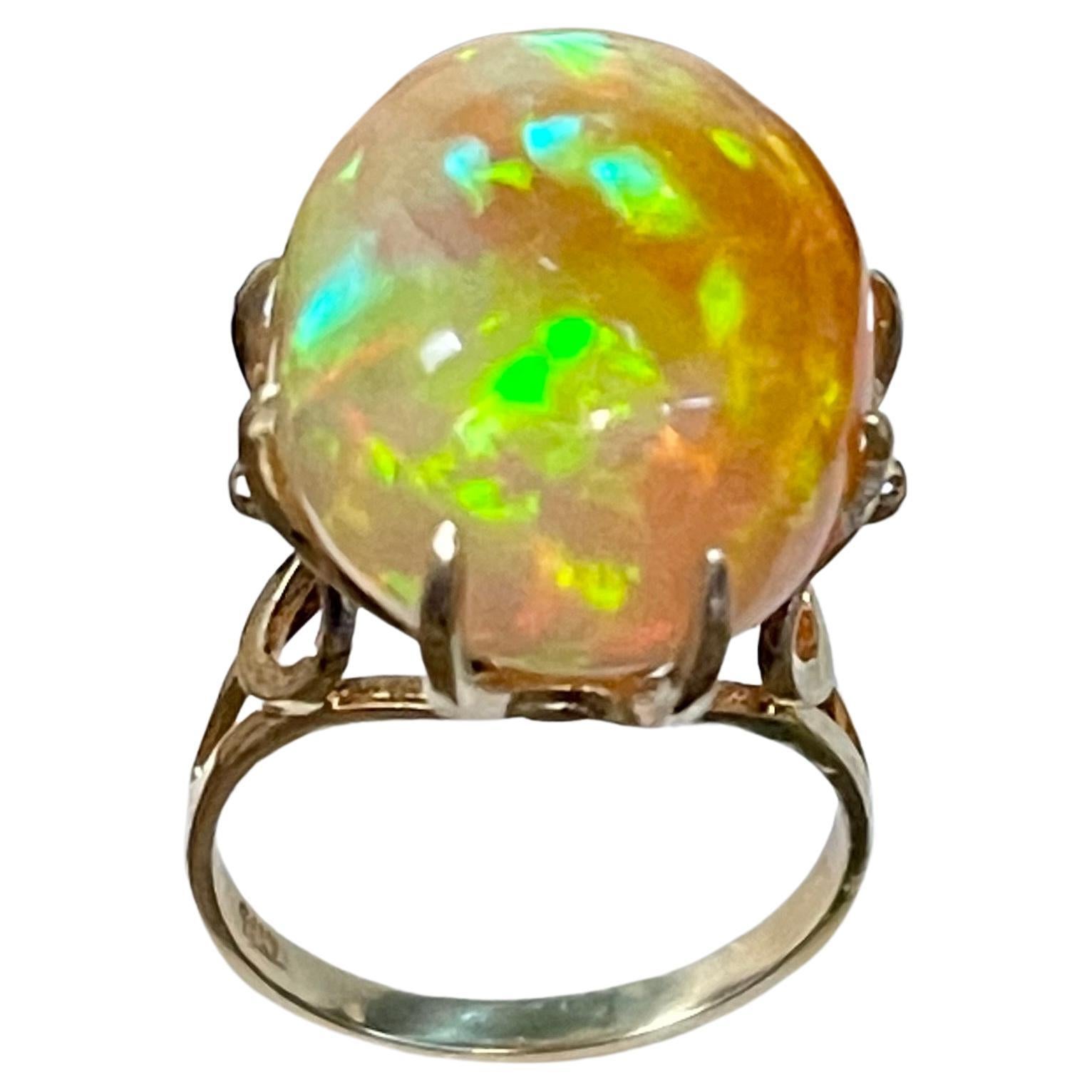 12 Carat Oval Shape Ethiopian Opal Cocktail Ring 14 Karat Yellow Gold size 6.5
Oval  Natural Opal  A classic, Cocktail ring 
14 Karat Yellow Gold Estate
Size of the opal 19 X 15 MM, Approximately 12 ct
Amazing colors in this opal and a great quality