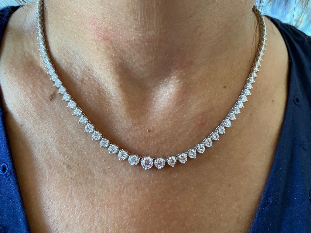 Graduated 3 prong diamond necklace set in 14K white gold. The center stone weighs 0.75 carats. The total carat weight of the necklace is 12.08. The color of the stones are G, the clarity is SI1-SI2. The necklace is 16 inches long.