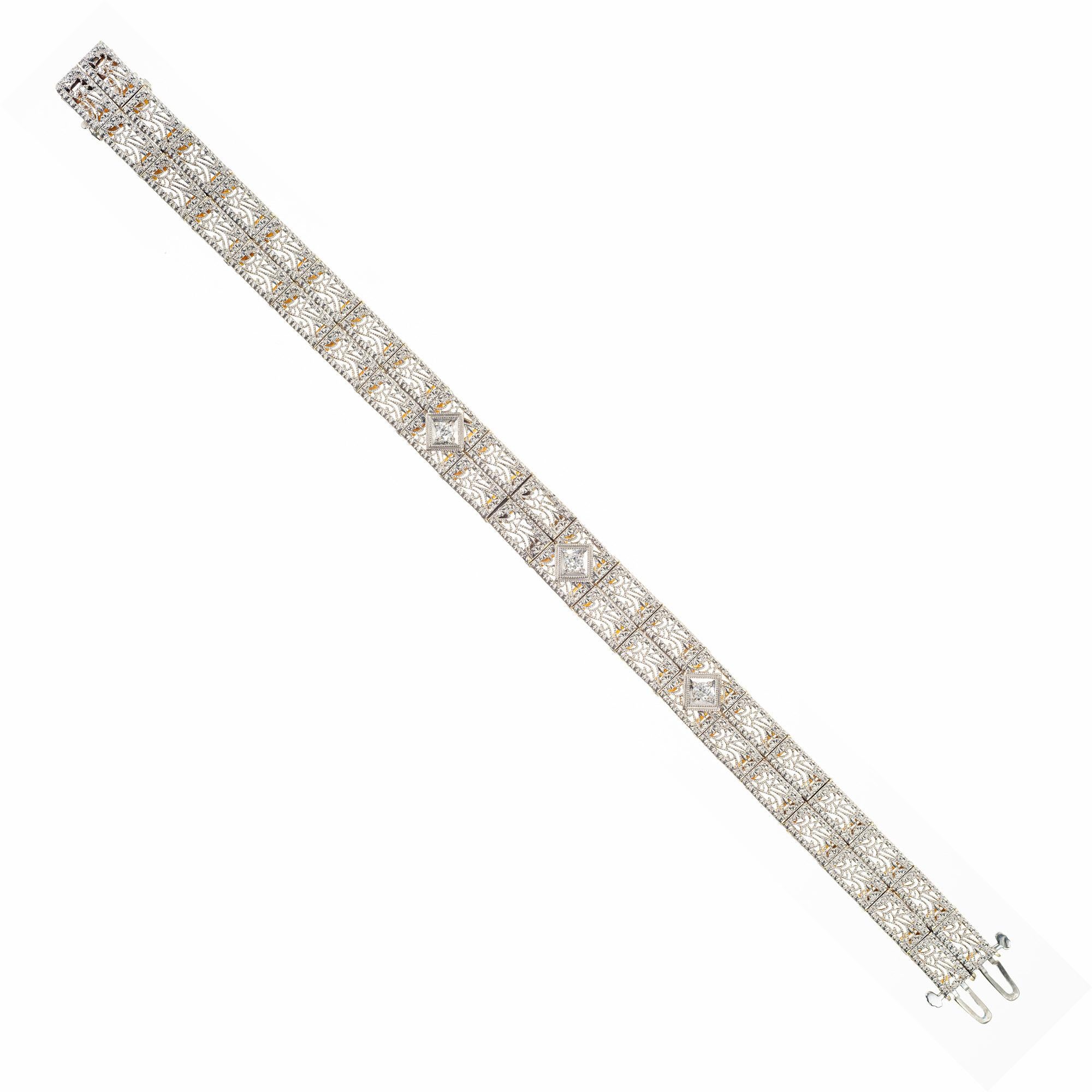 Captivating 9mm wide 14k white gold handcrafted filigree bracelet with 3 round diamonds equaling  .12cts. Circa 1930's. This bracelet features a double catch and underside safety for maximum protection to the wearer, while being extremely detailed