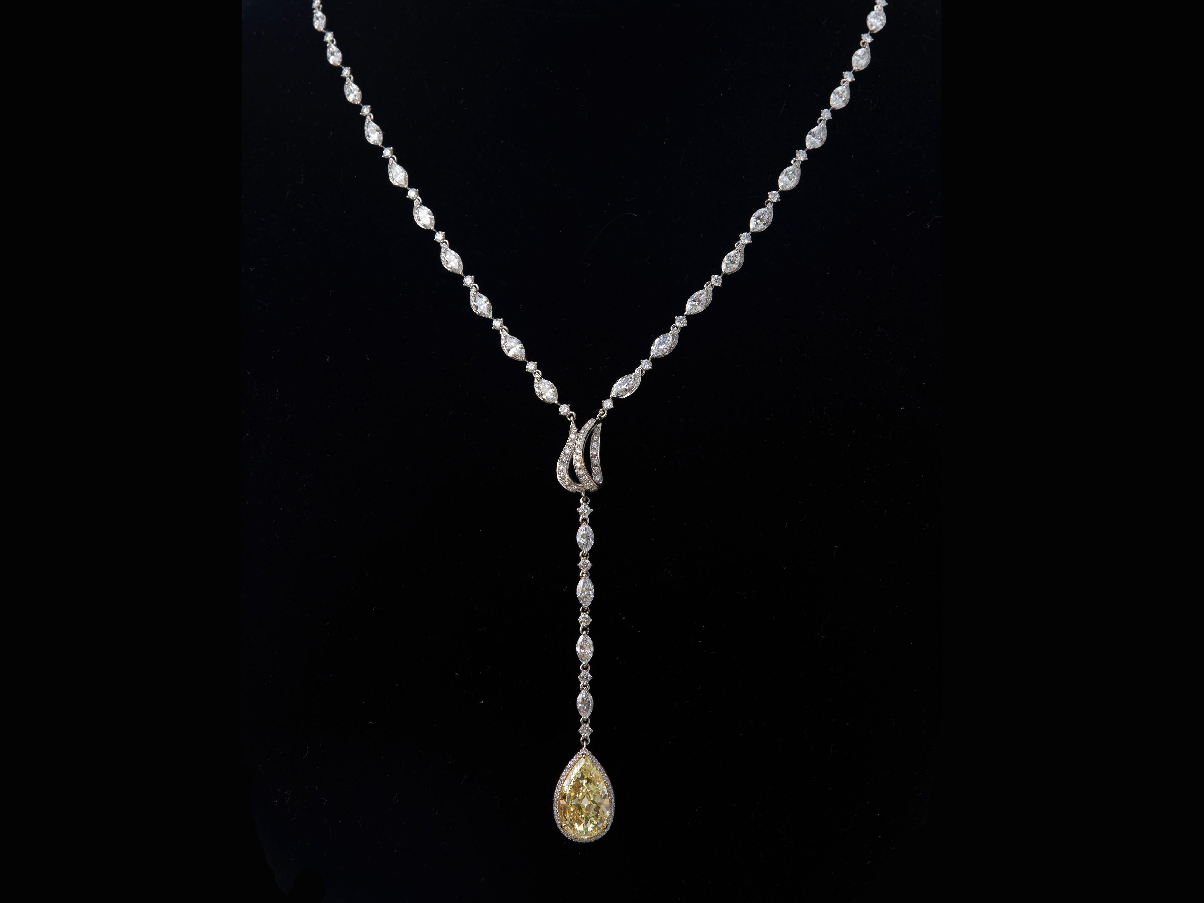 This luxurious design diamond drop necklace is simple but elegant. features Just under 4 carat Fancy Light Yellow Pear shape GIA certified, internally flawless and Excellent polish and symmetry diamond pendant, suspended with white diamonds. The