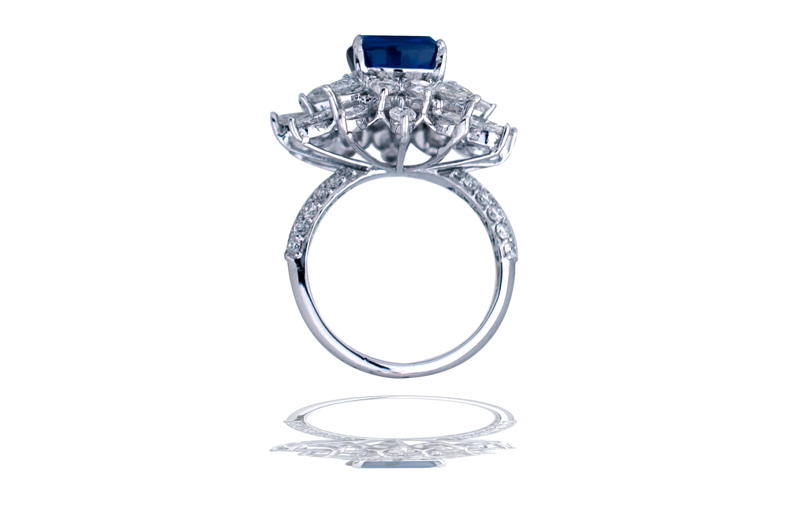 What a ring!  This stunner has a 10 x 10 mm appx. cushion cut sapphire set in the center .  The center stone is rich in blue color and has decent clarity.  The stone is surrounded by two rows of stunning white pear and marquise cut diamonds.  The