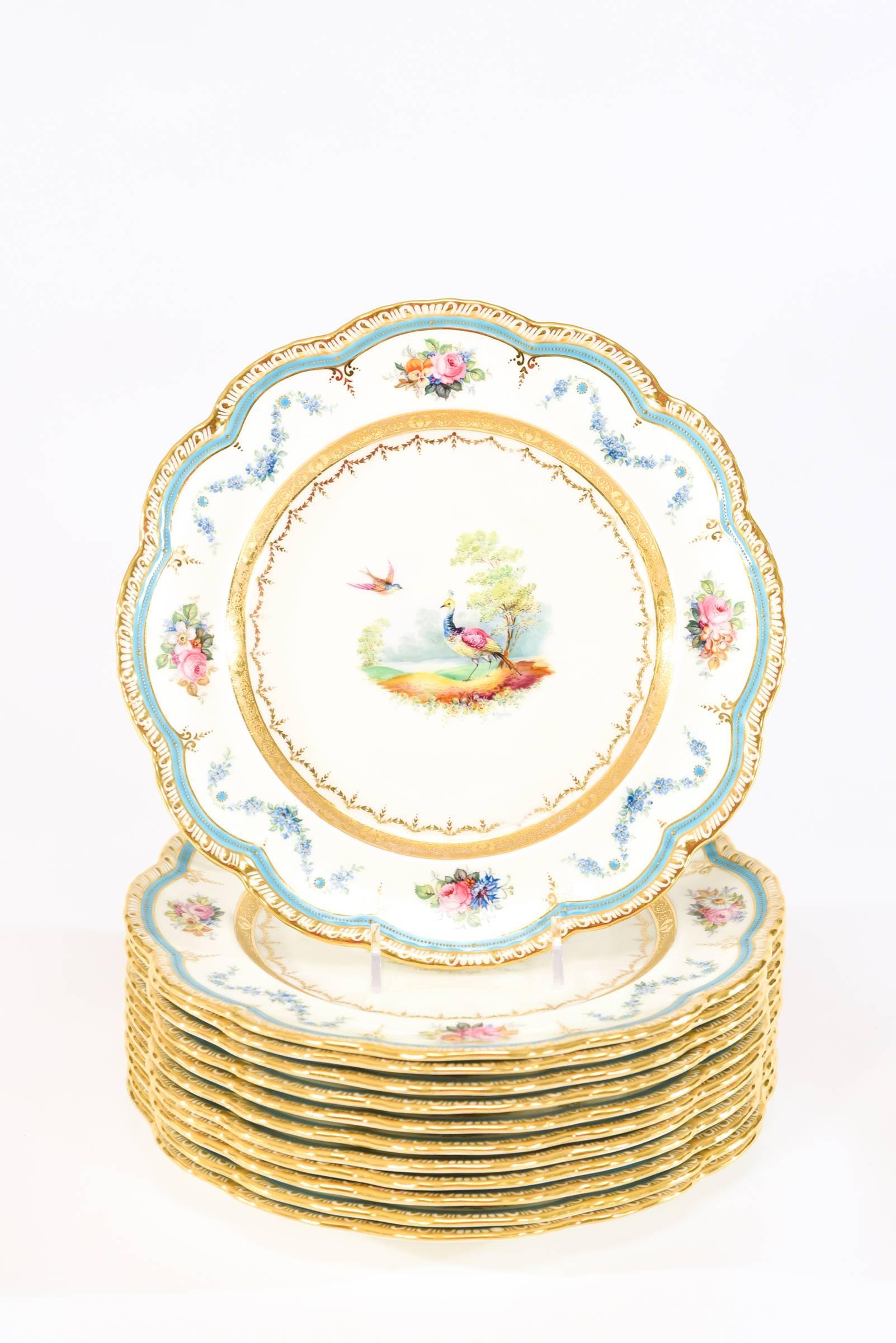 Turquoise is in! This set of 12 hand painted and artist signed dessert plates are presented with a piecrust border, trimmed in gold and highlighted with a band of turquoise enamel. The centers are uniquely painted, featuring various exotic birds.