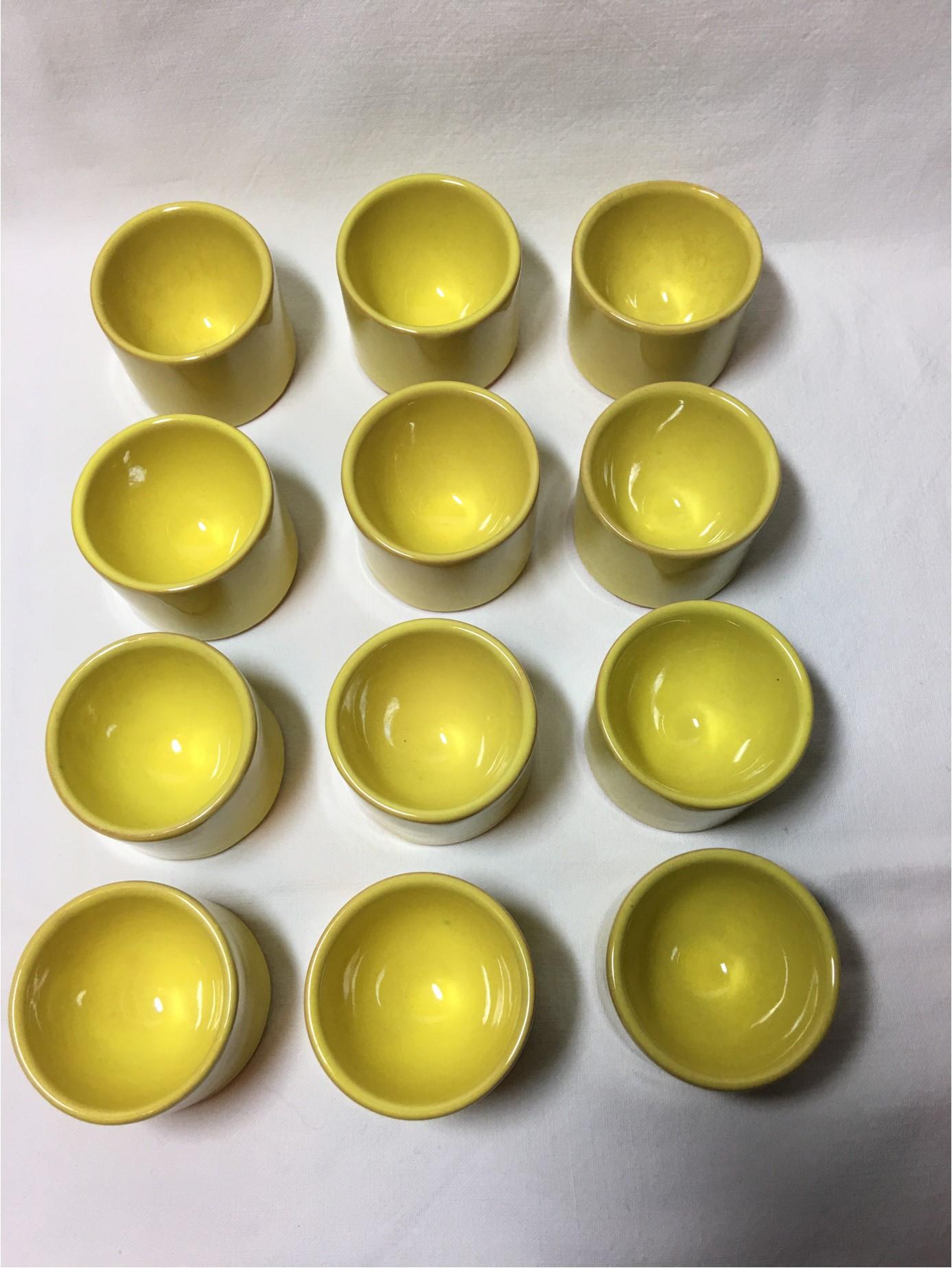 A dozen wonderful yellow Bijorn Winblad Rosenthal egg cups discovered recently in an attic. Never used and in excellent condition. These 1960s era egg cups are a set of two dozen that were found Yellow and Red. We can mix the color or ship solid