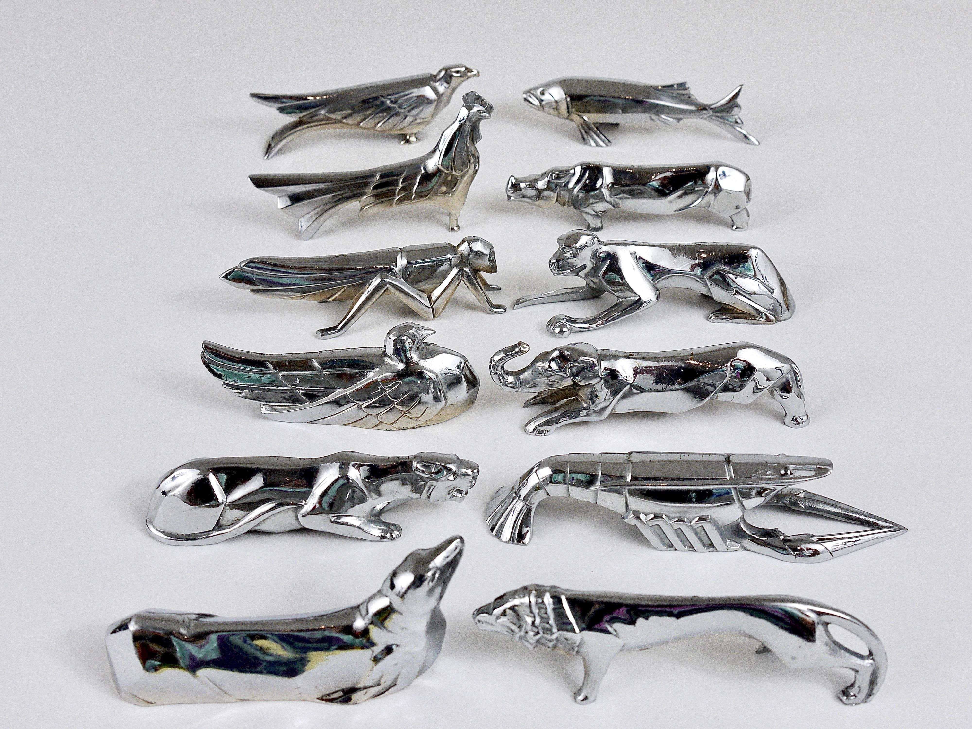 A set of 12 charming nickel-plated animal sculpture knife rests, displaying a rooster, a sea lion, a monkey, a lobster, a grasshopper, a rhino, an elephant, a lion, a fish, an eagle, a pigeon and a panther. Made in France in the 1930s. In very good