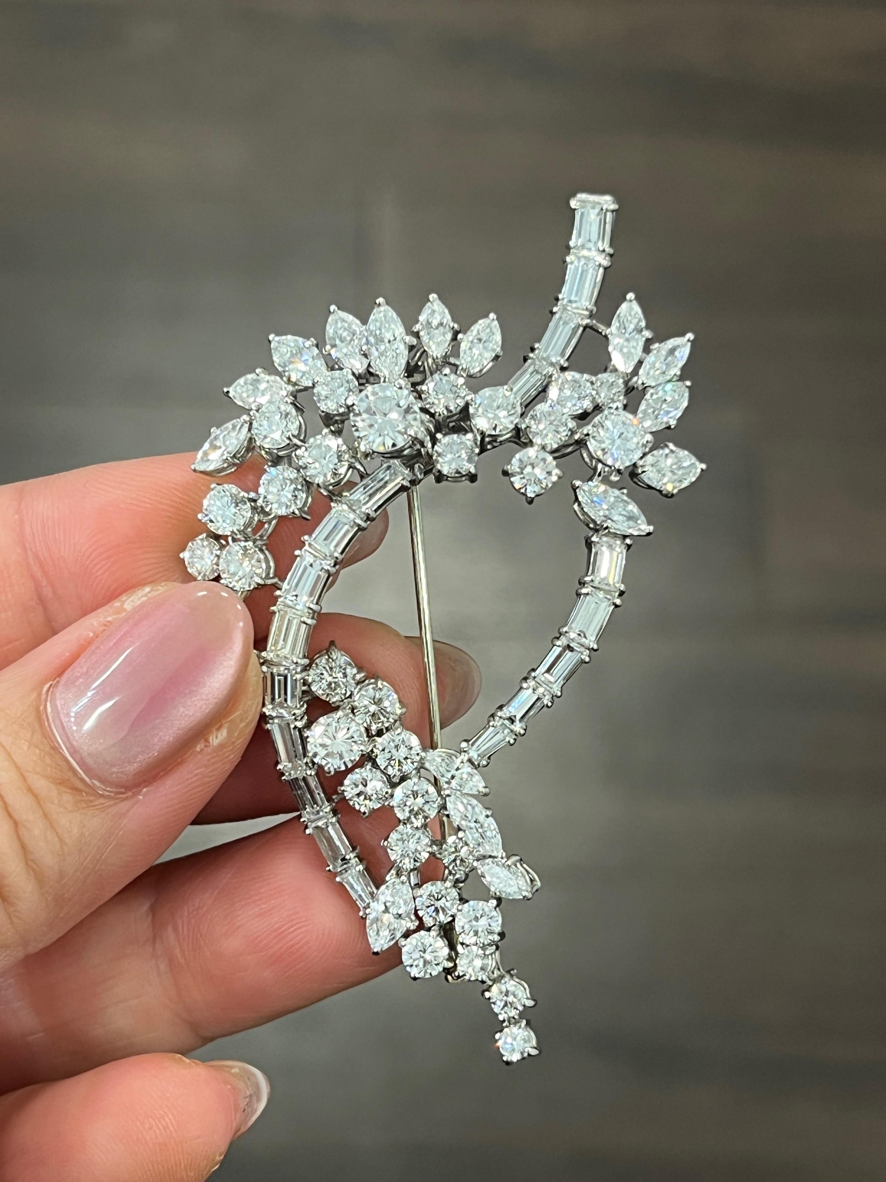 This antique brooch features round, marquise, and baguette shape diamonds weighing approximately 10.00 ct. The diamonds are set in platinum and graded E/F in color, and VS1/VS2 in clarity.

