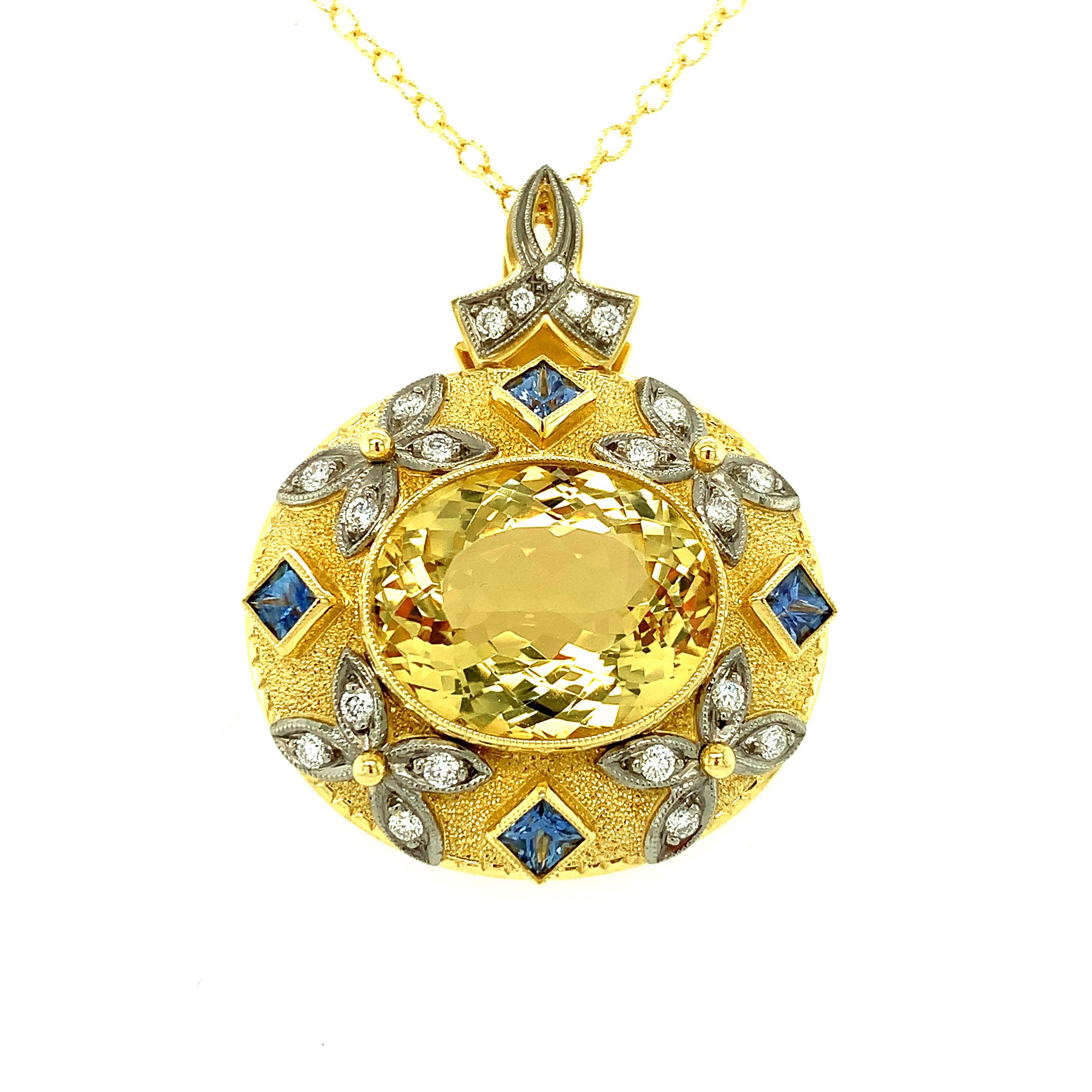 This Renaissance-inspired pendant features a large, 12 carat sparkling chrysoberyl with blue sapphires and diamonds set in 18k white and yellow gold. Faceted chrysoberyl may not be as famous as its color-change cousin, alexandrite, but gem