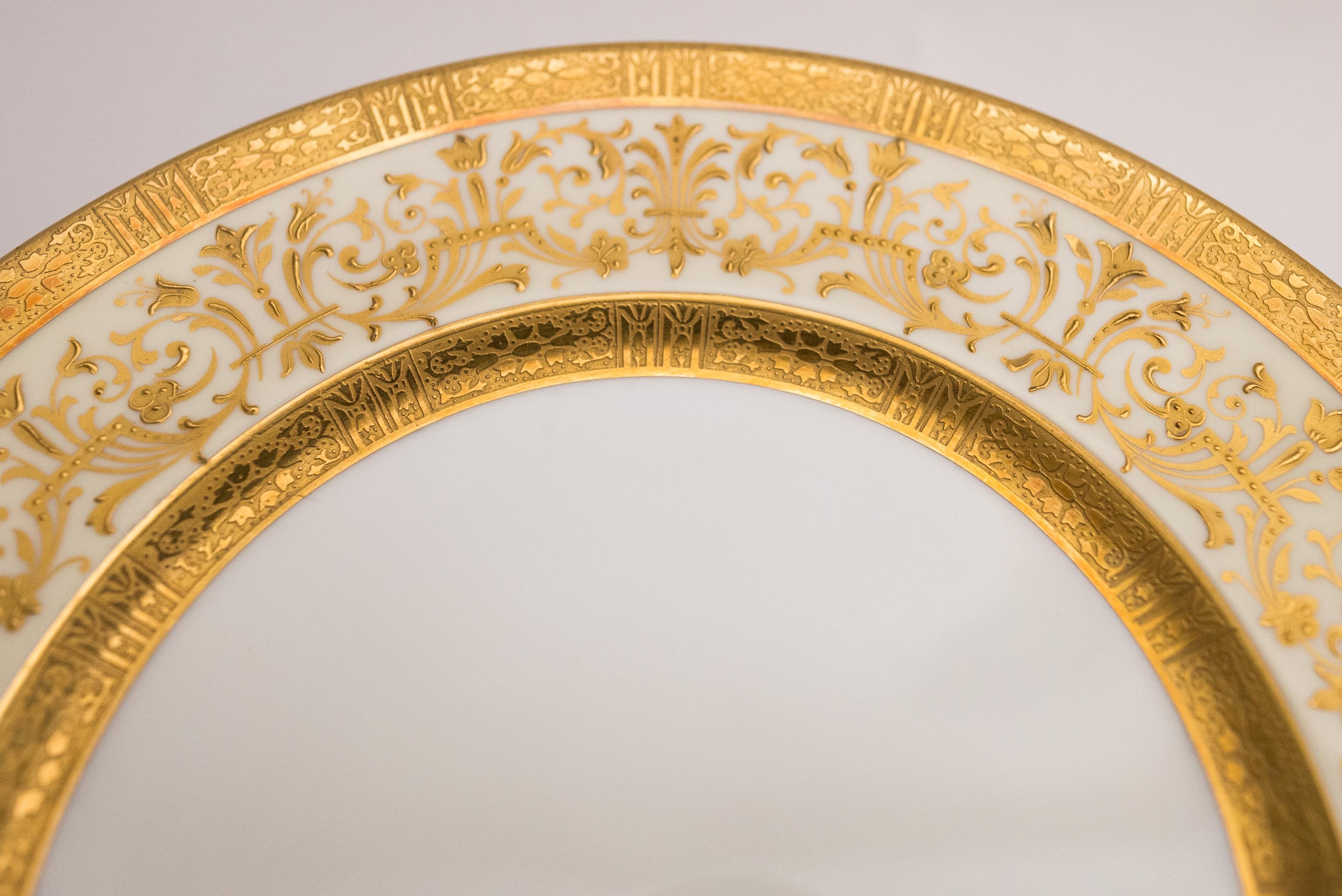 An elaborate raised paste gilt collar with double acid etched 24 karat gold bands from the re known Gilded Age porcelain manufacturer Cauldon, England. This suite of 12 plates were custom ordered through the fine retailer John Wanamaker New York. In