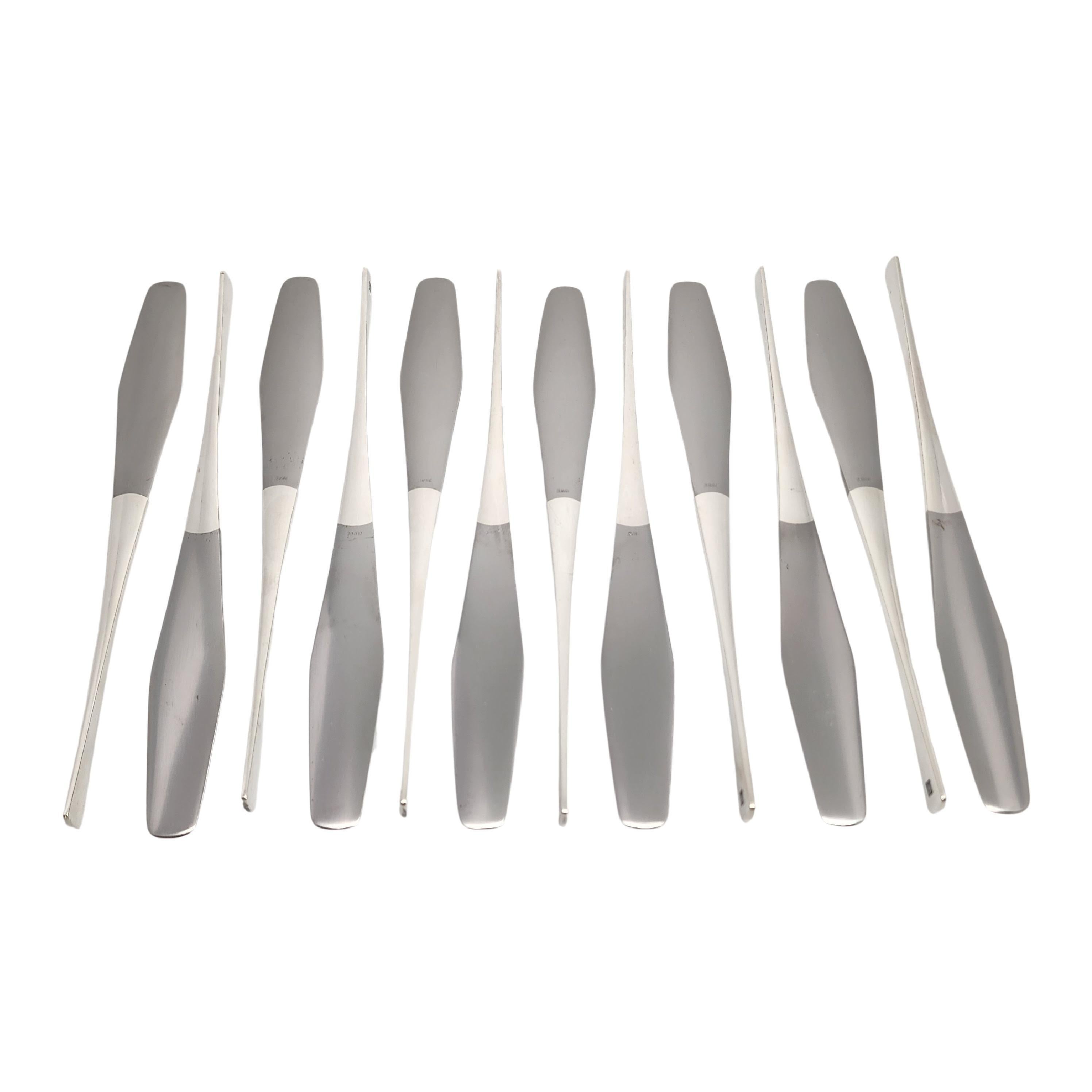 Set of 12 sterling silver handle, stainless blade knives in the Tjorn pattern by Dansk.

No monogram

Mid-Century modern knives designed by Jens Quistgaard in 1959. Classic Scandinavian modern design, these knives feature a 90 degree turn from the