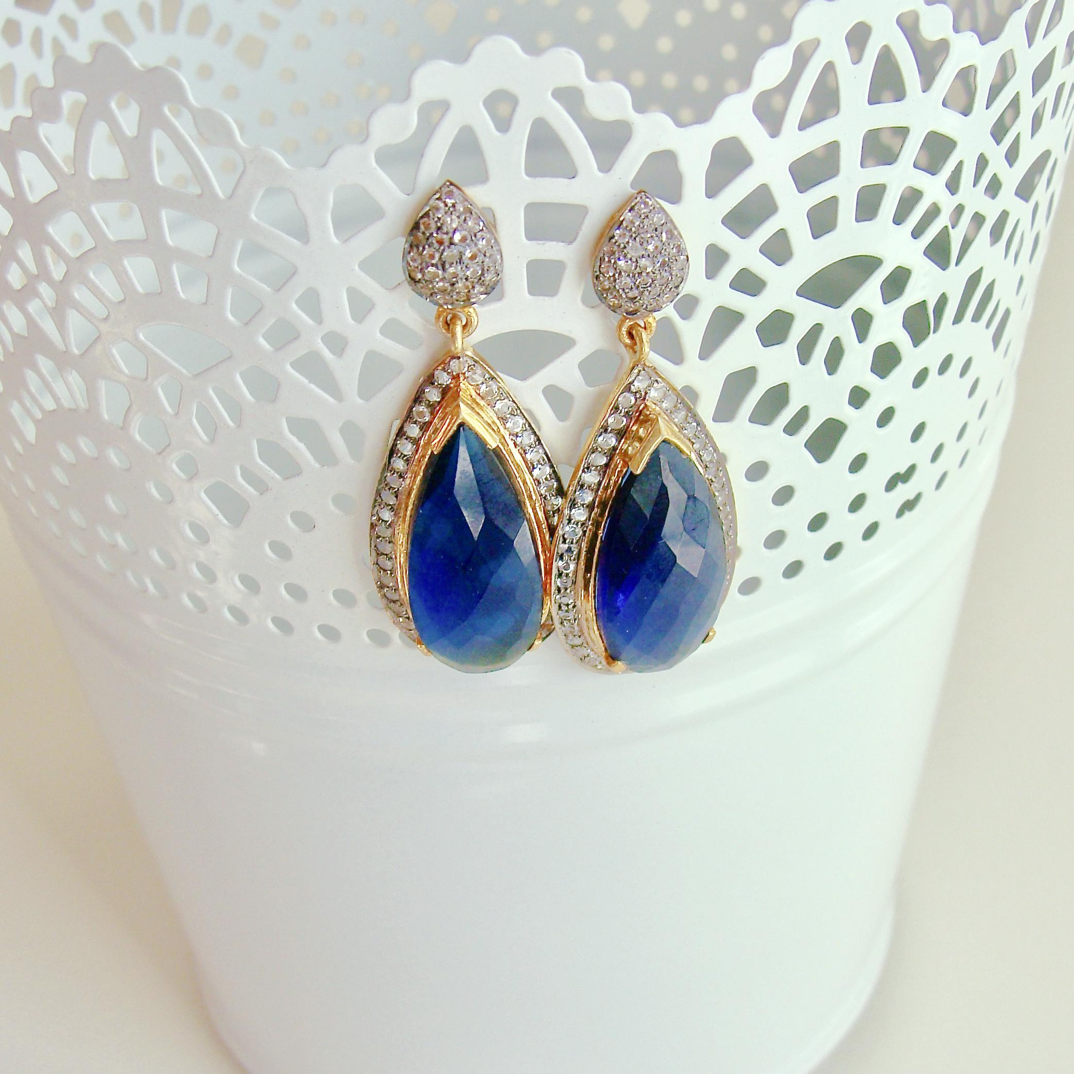 12 Days of Chrstmas = Blue Hydroquartz w White Topaz Posts  - Blue Hydro Quartz Earrings

Originally $360.00  On Sale $270.00

These man made hydroquartz elongated earrings are surrounded by white topaz and capped with a leaf shaped white topaz