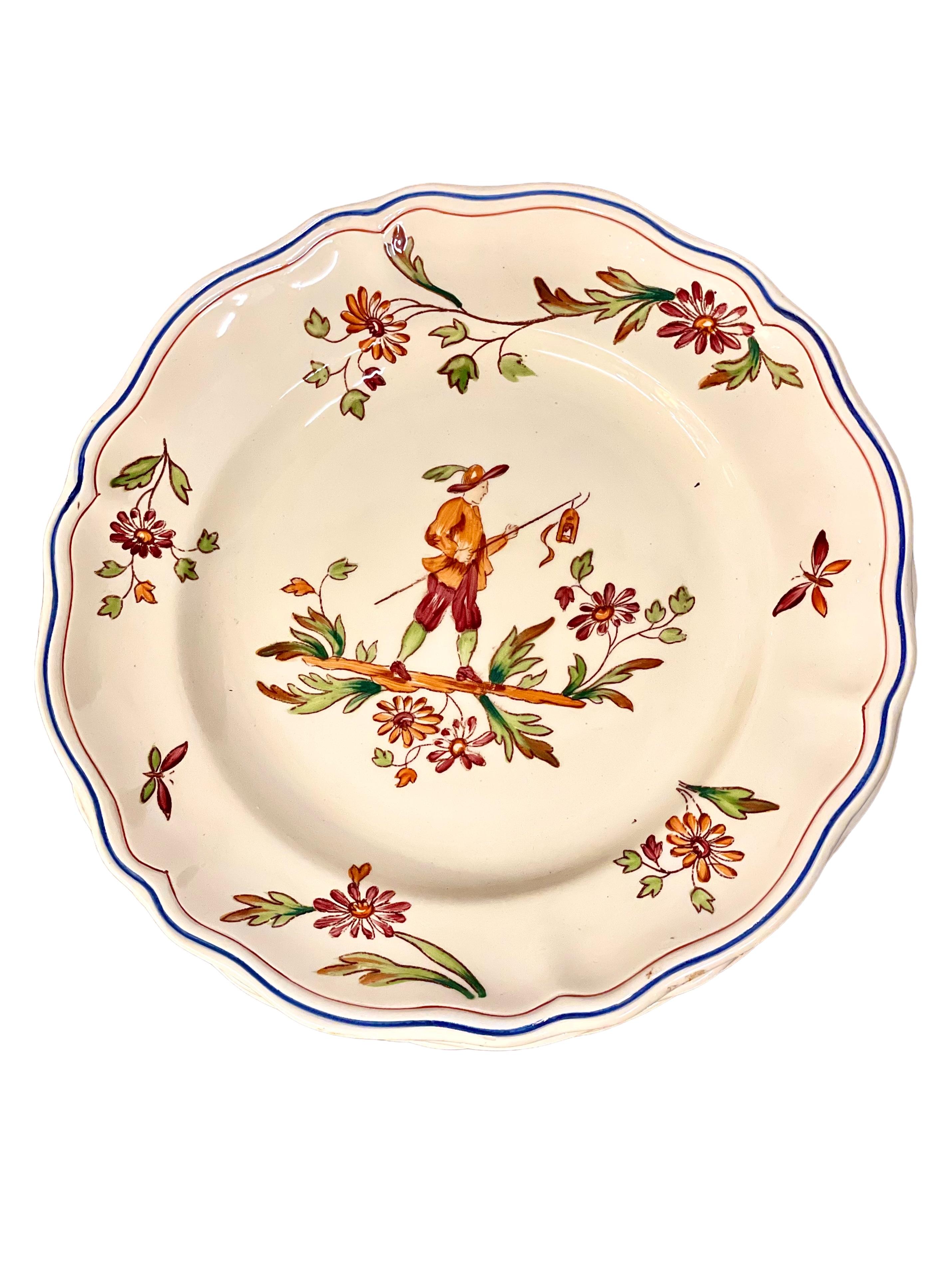 A charming set of 12 dinner plates made by the renowned Burgundy-based earthenware specialists Longchamp, and dating from around 1950. The pattern is called 'Moustiers', which is itself a French provençal village with a history of earthenware