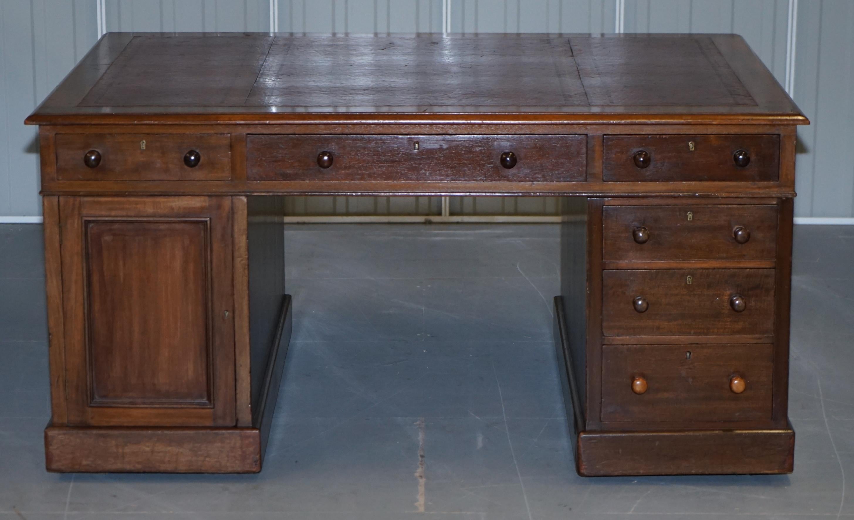 We are delighted to offer for sale this monumental solid mahogany 12 drawer 2 cupboard twin pedestal partner desk with oxblood leather writing surface 

This desk is large and in charge, its naturally designed for two “Partners” to share, the