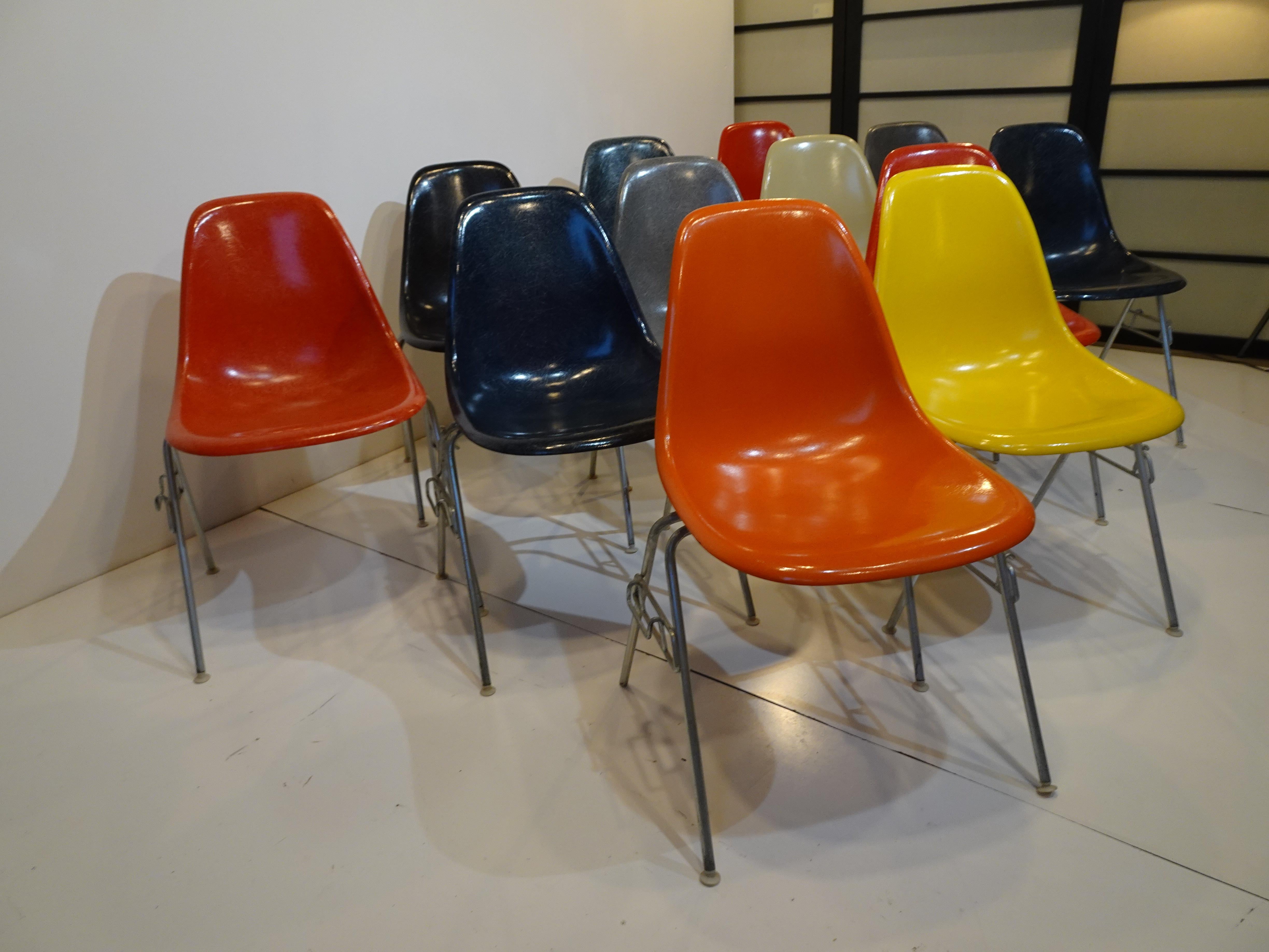 A set of twelve stacking DSS fiberglass side scoop chairs with zinc bases, this set includes a rainbow of the manufactures colors from the 1960's. Included in the set of colors are yellow, dark blue, black, orange, gray, red, elephant hide and