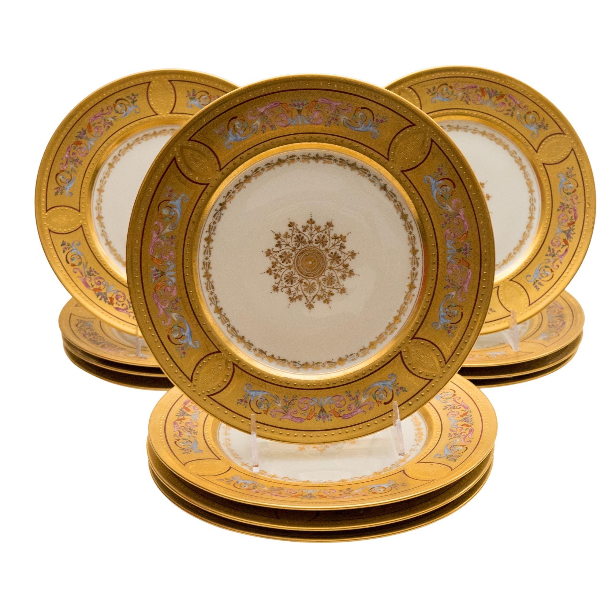 A wonderful hand enameled with central medallion design set of 12 plates. Richly gilded and vibrantly painted throughout their collars. Rare and in wonderful antique condition.