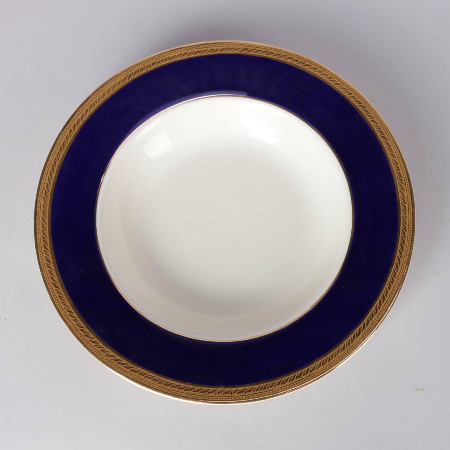 Set of 12 English fine china porcelain soup bowls by Crown Ducal feature cobalt wide rim trimmed in gold gilt, en verso 