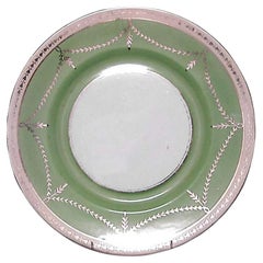 12 English green-and-white porcelain dinner plates with gold swag design 12 English green-and-white porcelain dinner plates with gold swag design